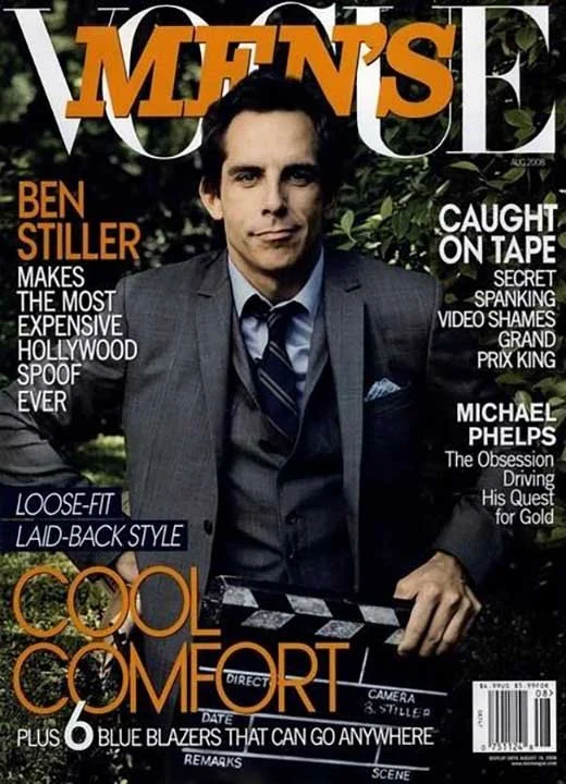 The cover of a magazine featuring a man in a suit with dark hair, sitting outdoors with greenery in the background. The magazine highlights include articles about Ben Stiller and Michael Phelps, with headlines such as "Caught on Tape" and "Cool Comfo