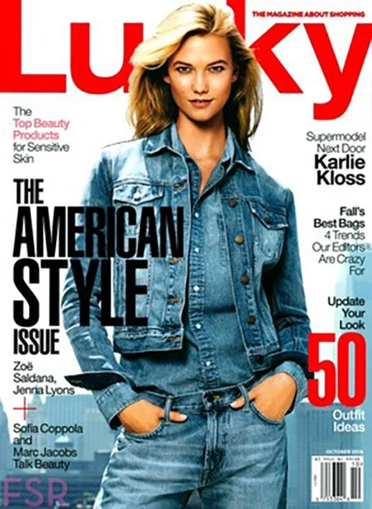 Magazine cover of Lucky featuring a young woman with blonde hair wearing a denim jacket and jeans, with her hands in her pockets, looking at the camera.