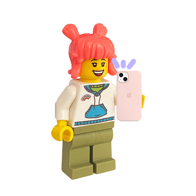 Lego minifigure with pink hair taking a selfie with a pink iPhone, standing in front of a colorful striped background.