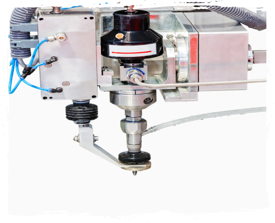 Close-up of a mechanical device with metal components, wiring, and a black cylindrical part, possibly part of a machine or robotic system.