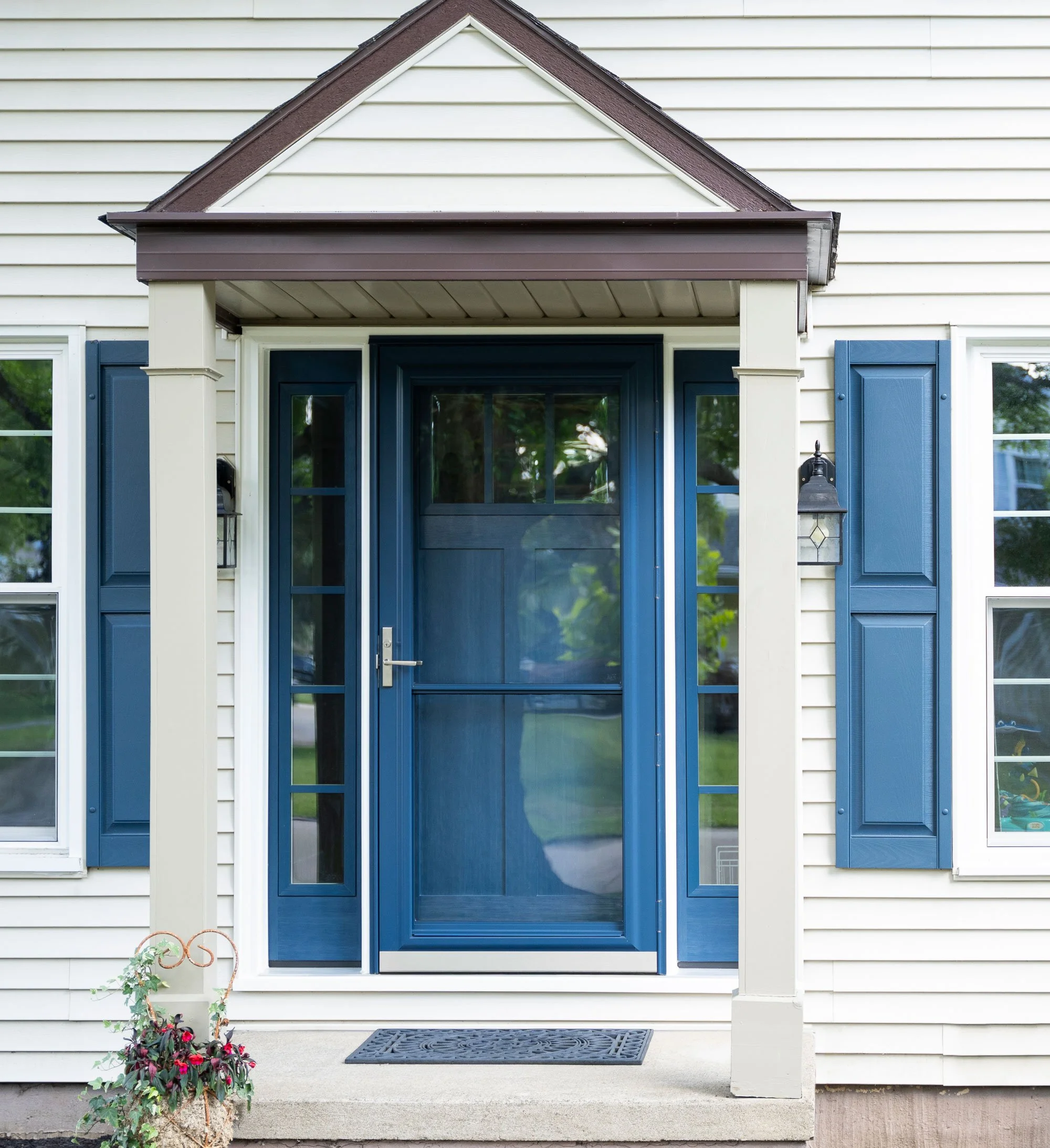 House with ProVia Spectrum 291 Full View Storm Door in the color Deep Waters with Signet Fir 420 Sidelites and Colonial SDL Grids