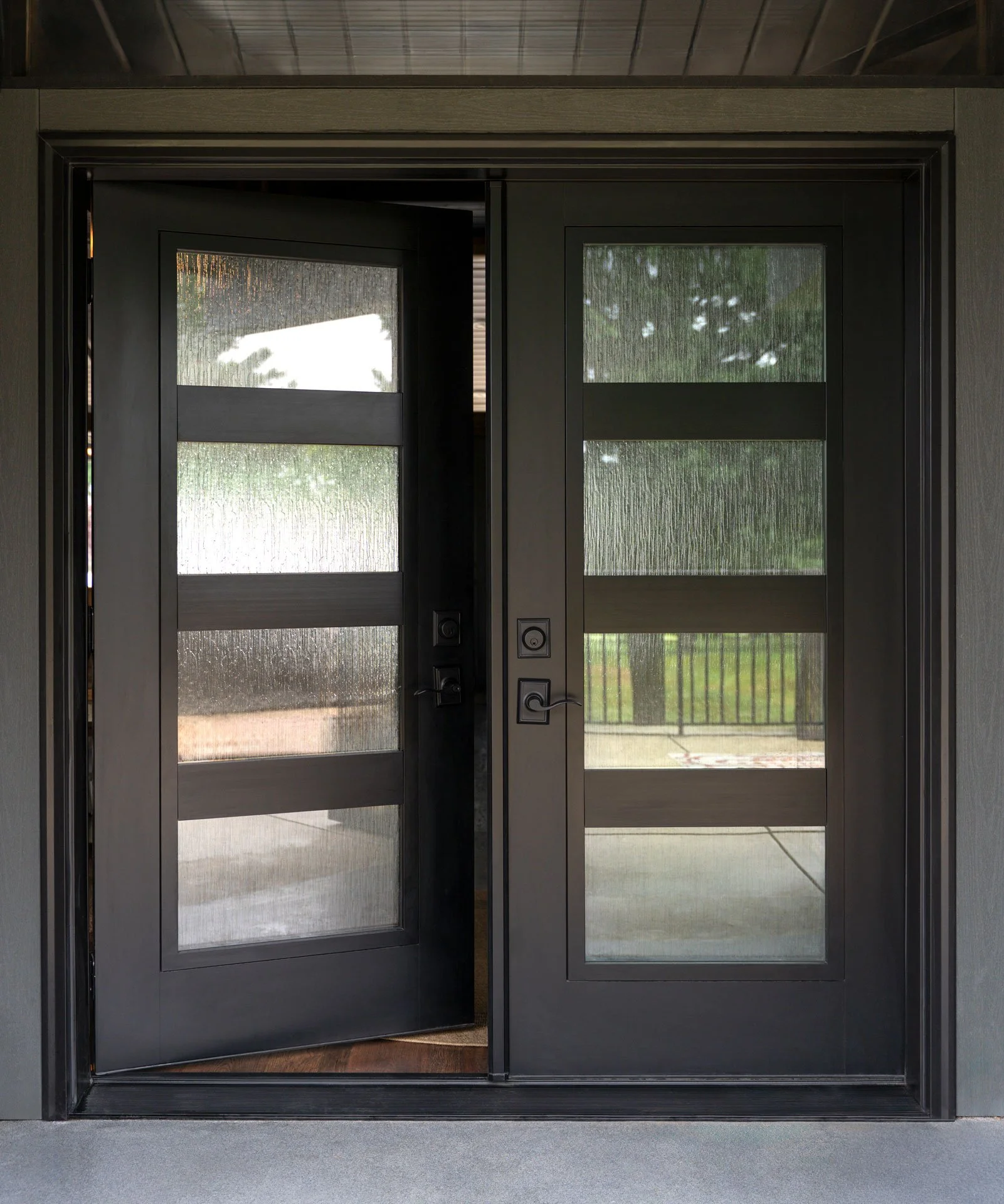 House with ProViaHouse with ProVia Signet Smooth French Door in the color Coal Black with Waterfall Privacy Glass