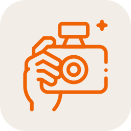 Icon of a hand holding a camera