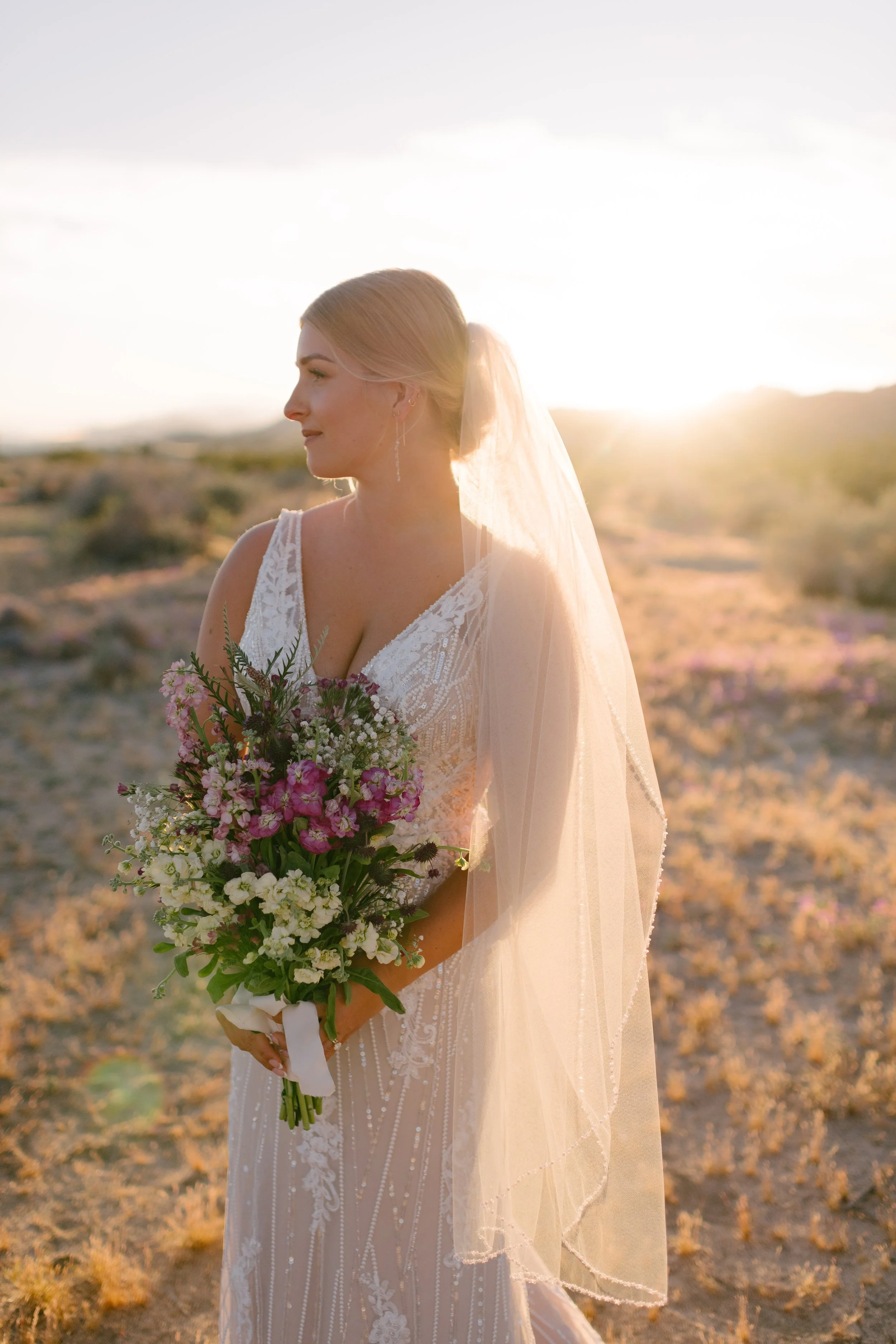 Bride in Joshua Tree National Park at sunset by Everywhere Elopements