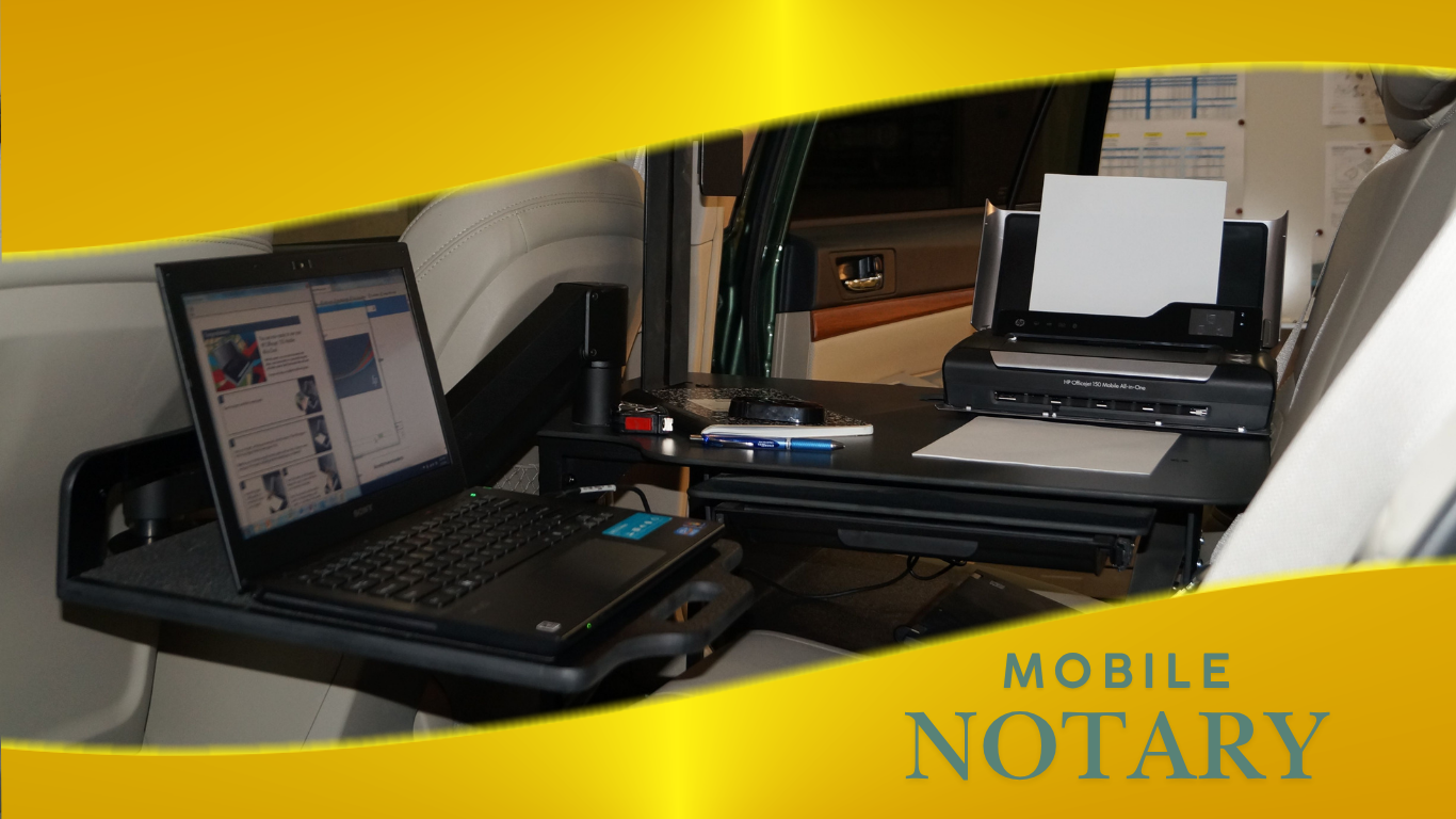A mobile notary setup inside a vehicle with a laptop, printer, pens, and papers.
