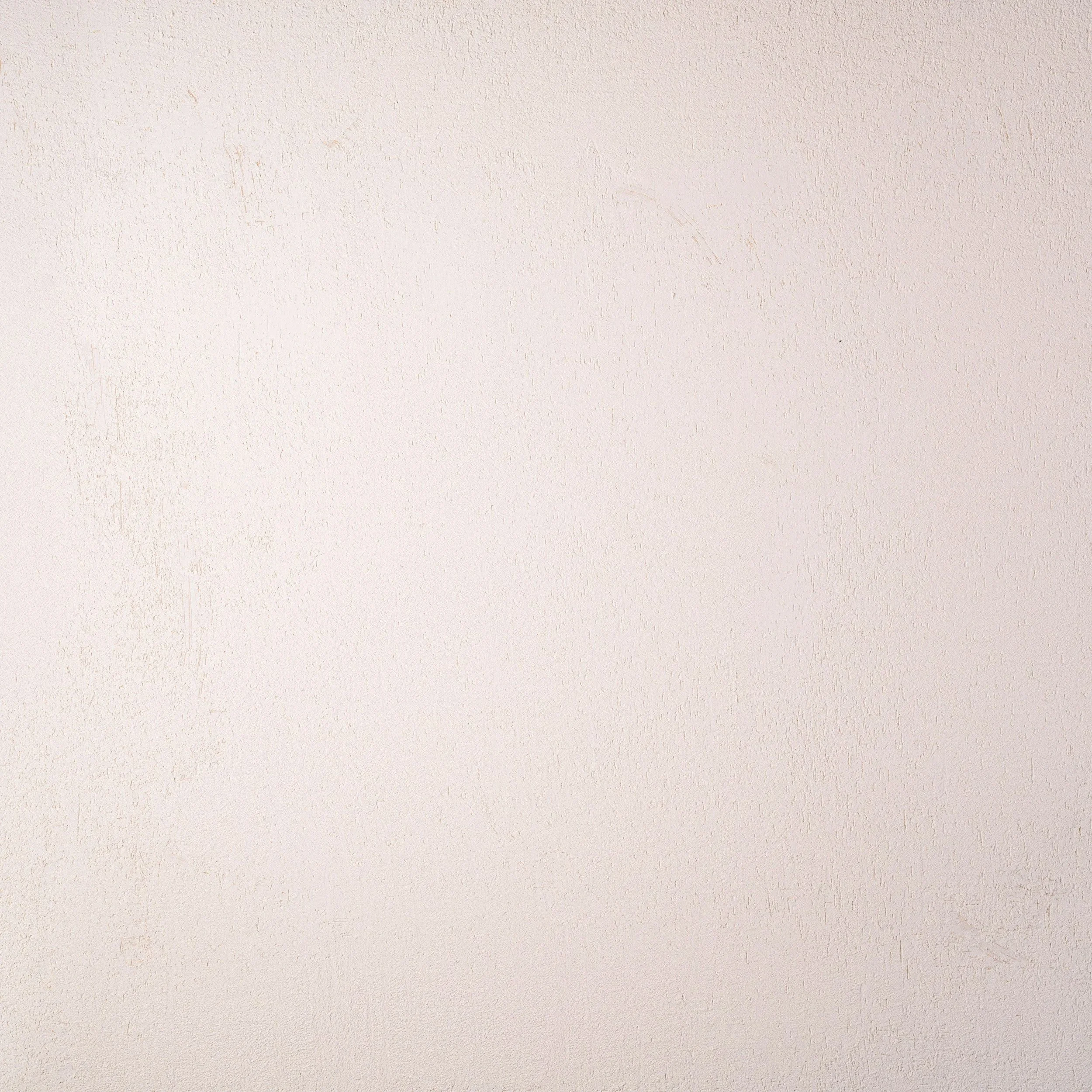 Plain, light-colored wall with a slightly textured surface.