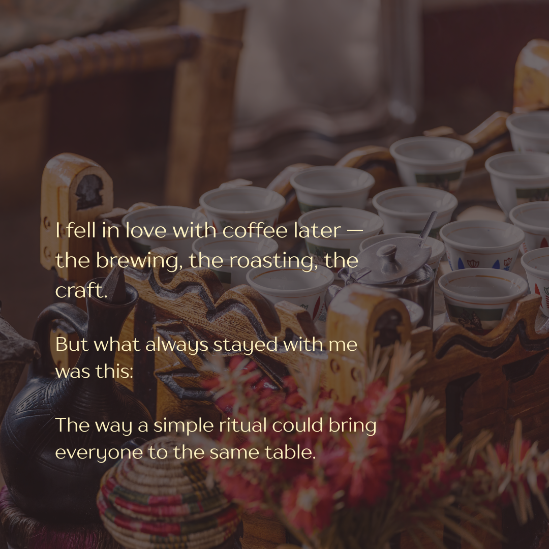 A tray of small coffee cups, a teapot, and a decorative basket with flowers on a rustic wooden table.