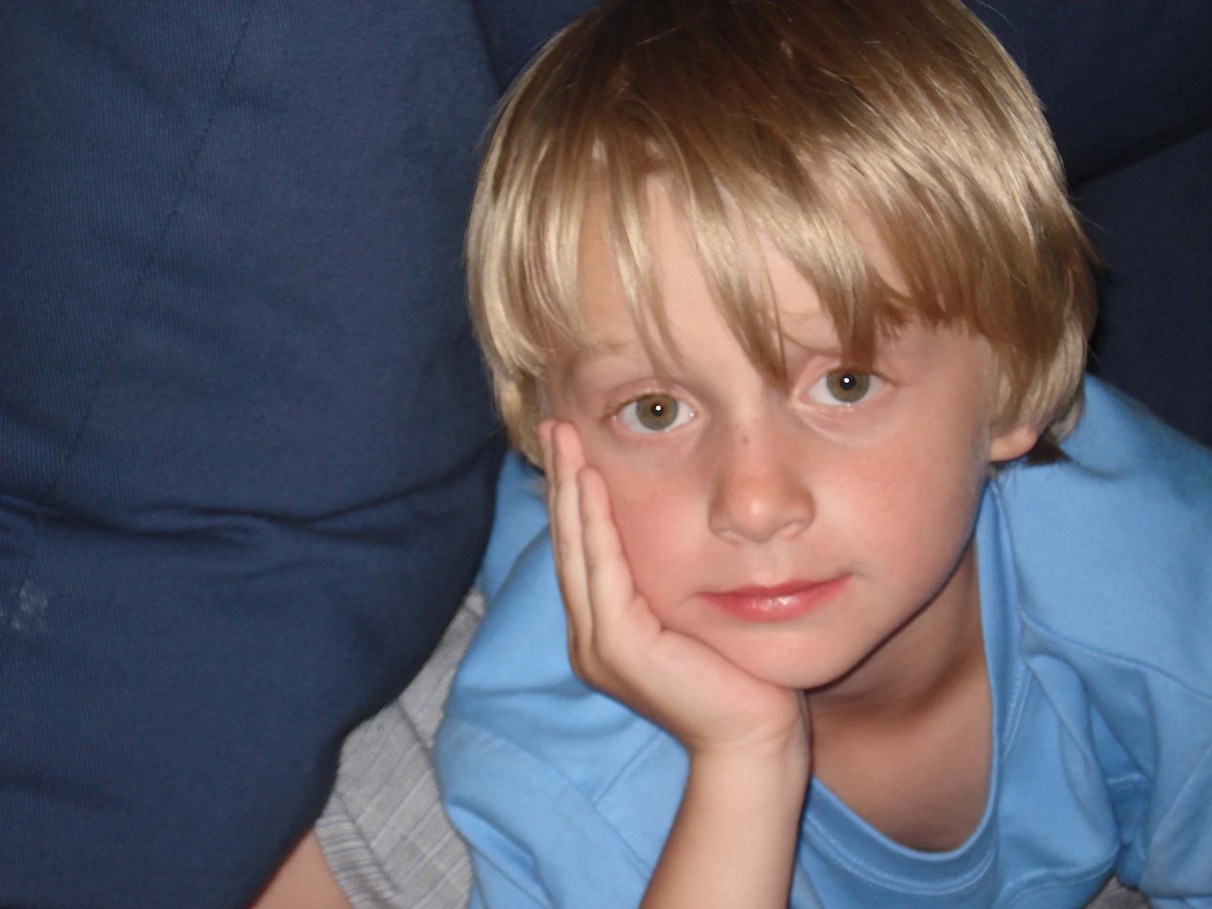 Young Owen with hand on his face. Waiting for someone to reach out so they can talk.