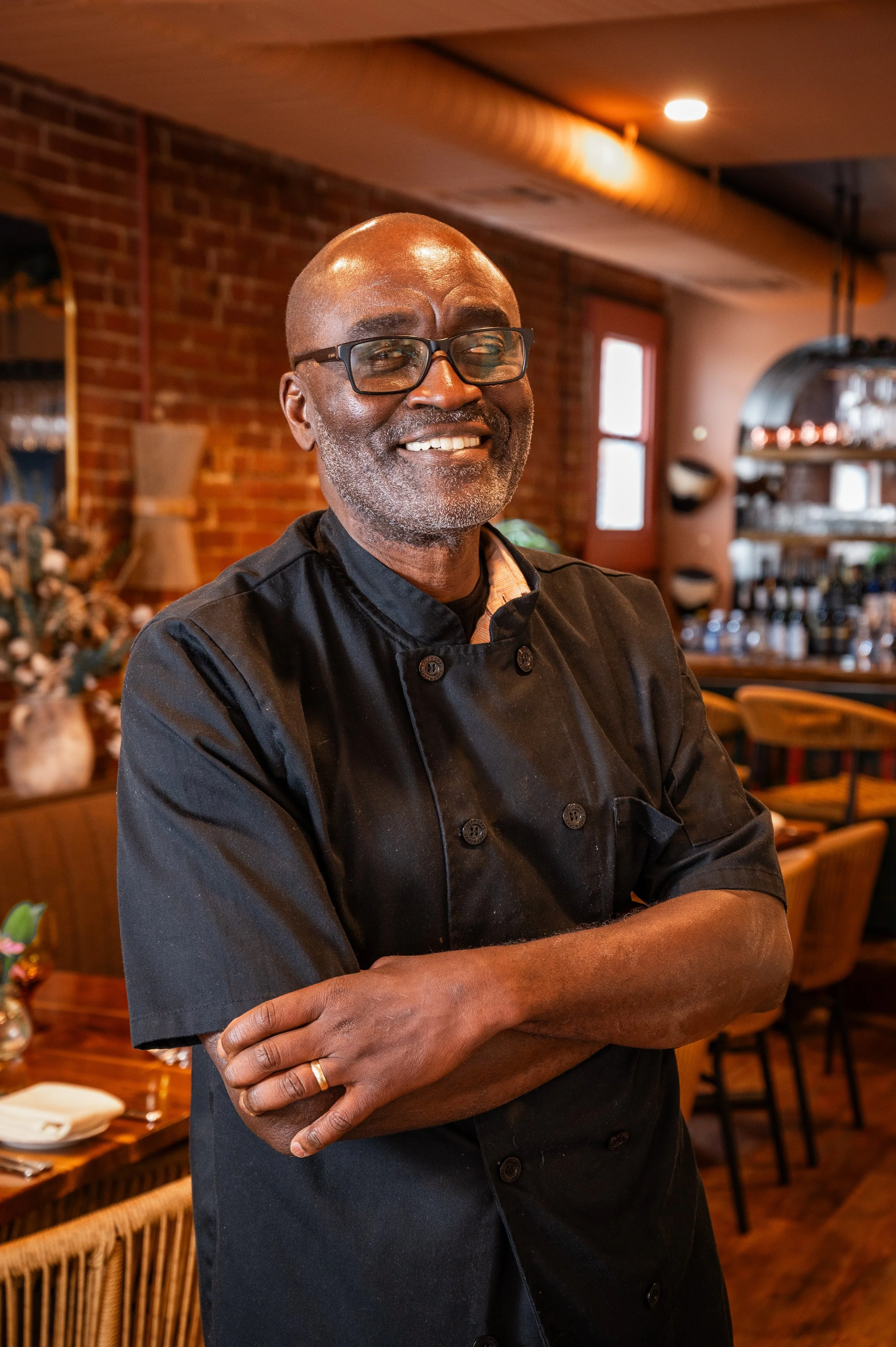 Co-owner, Felix Addison, is wearing a chef jacket in the restaurant.