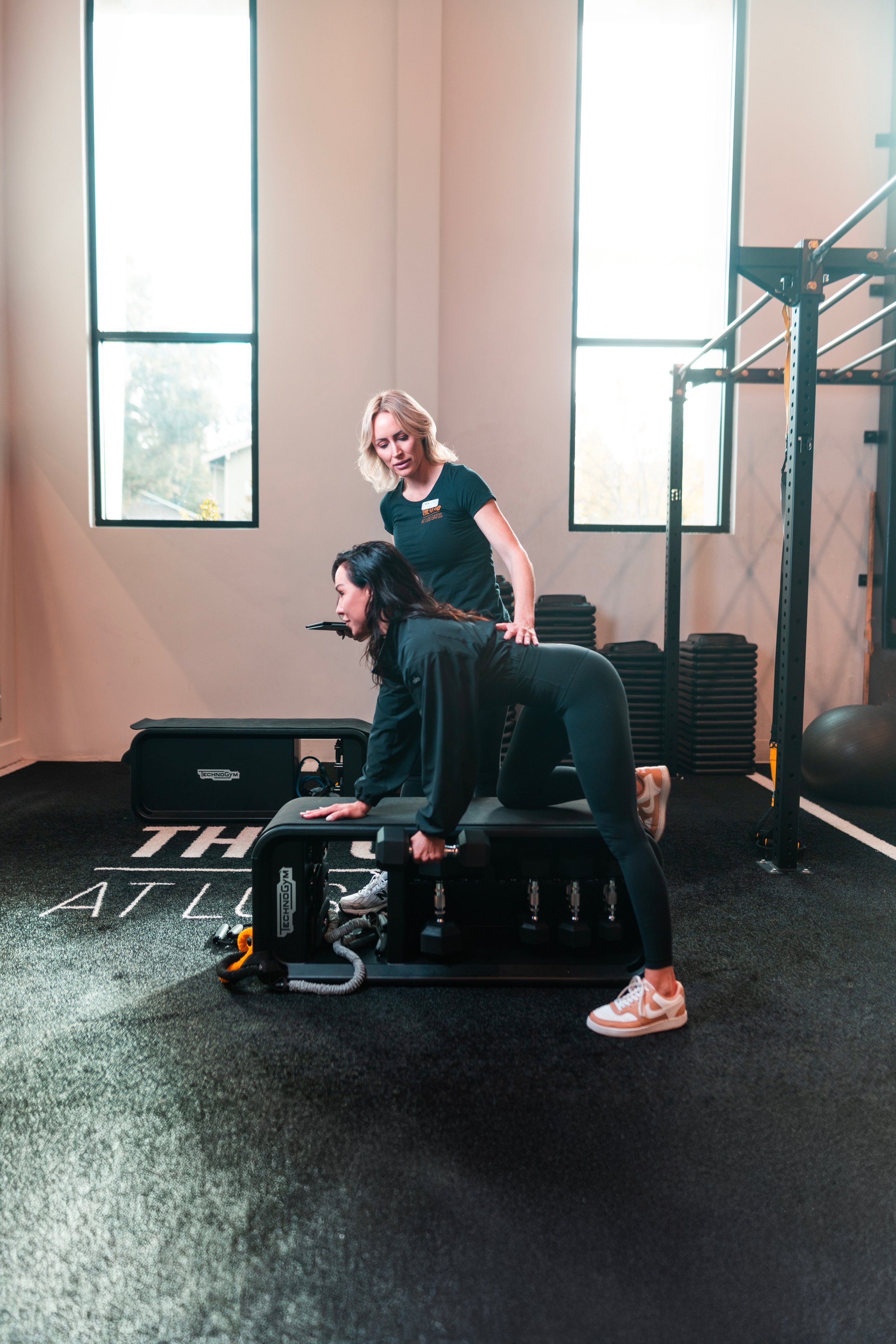 Member building strength with an expert personal trainer during a customized training session at The Club at Los Gatos.