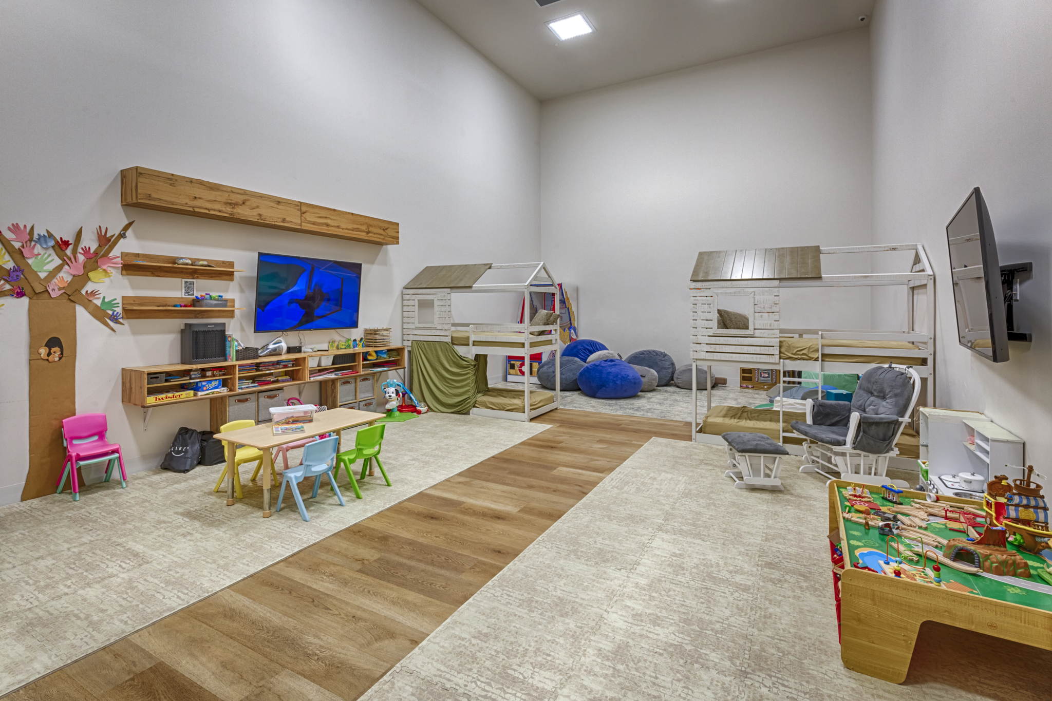 A Kids Club playroom with various toys and games, art supplies, activities, a playhouse, educational tv and books, Gymnastic exercise equipment, dedicated infant play zone