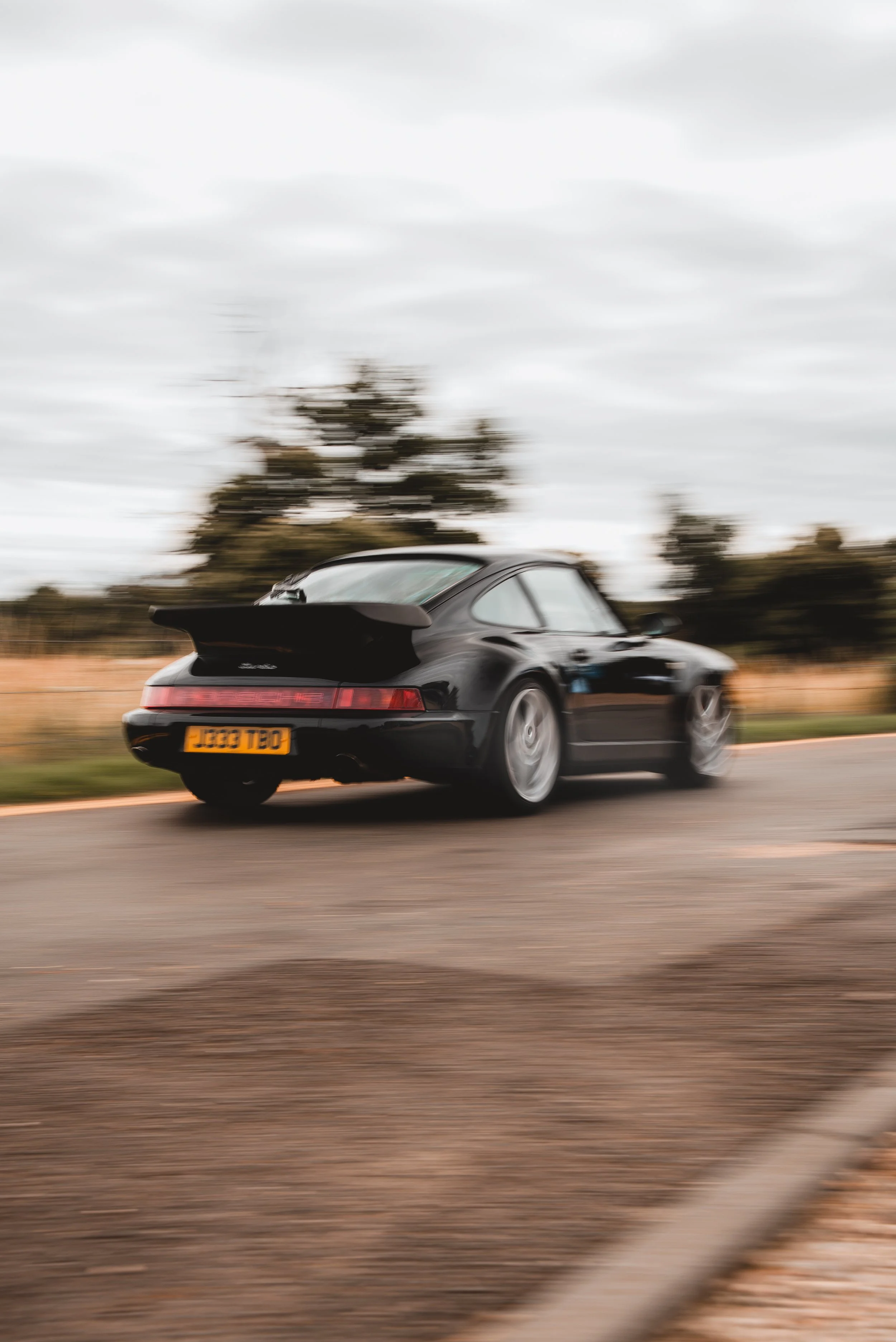 Porsche driving along a UK country road