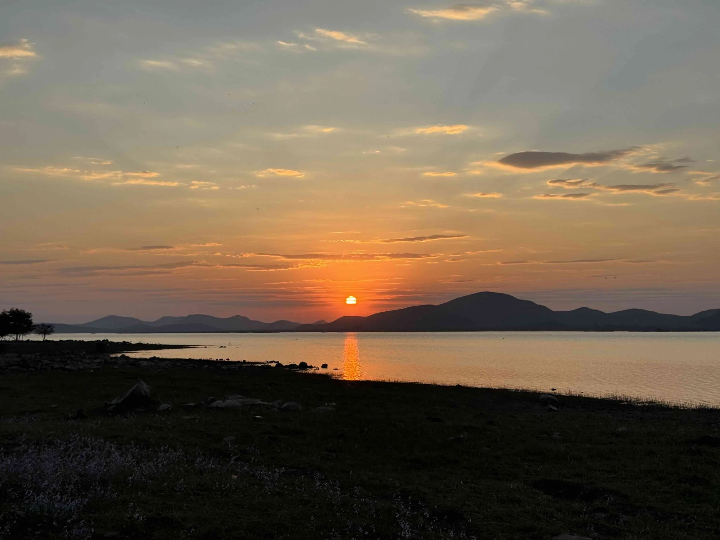 Sunset at Gaborone Dam in Botswana view onto the lake and hills