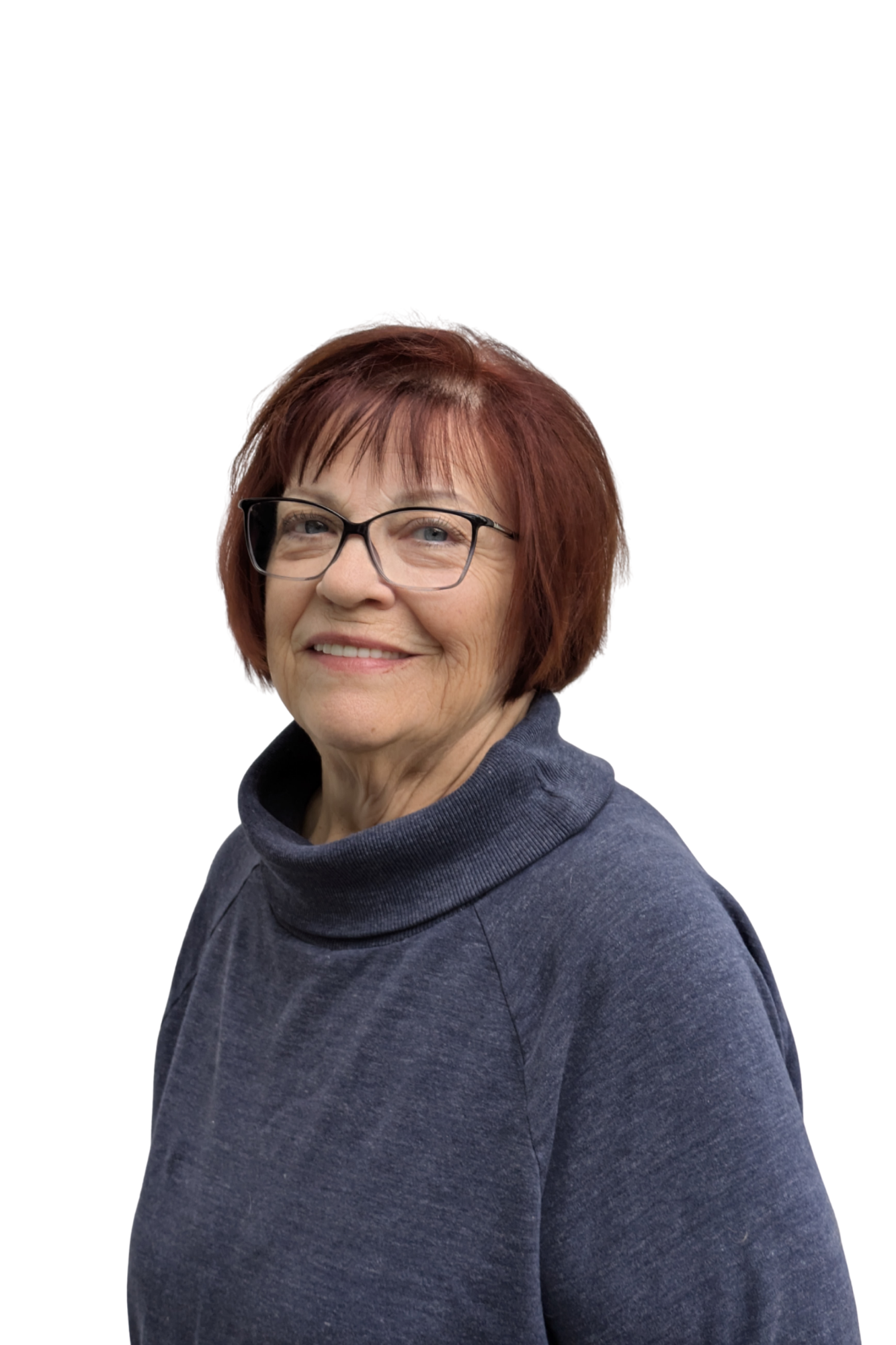 Portrait of a middle-aged woman with short reddish hair, glasses, wearing a dark blue hoodie, smiling against a plain white background.