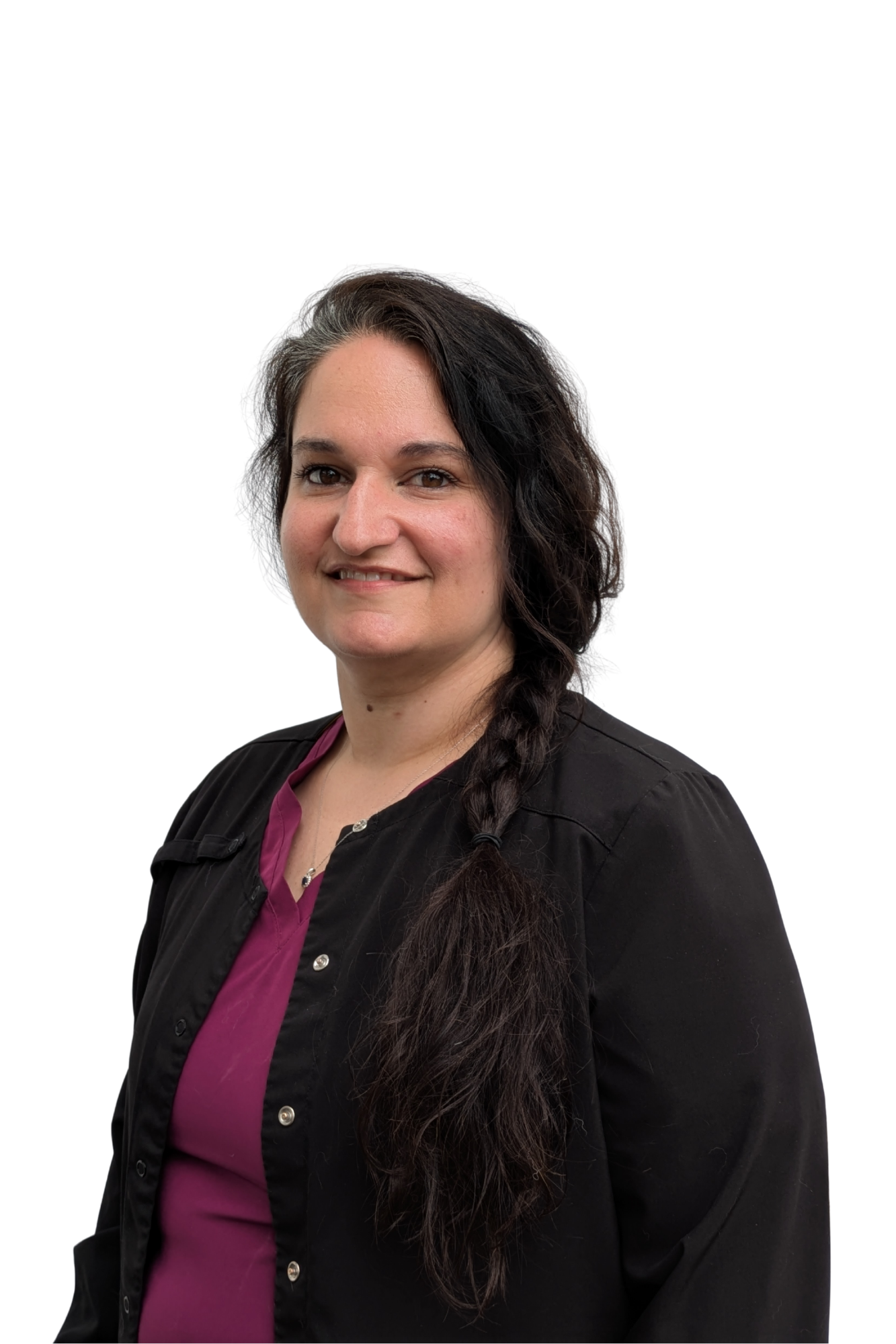 A woman with long dark braided hair, smiling, wearing a black jacket over a purple blouse, against a plain white background.