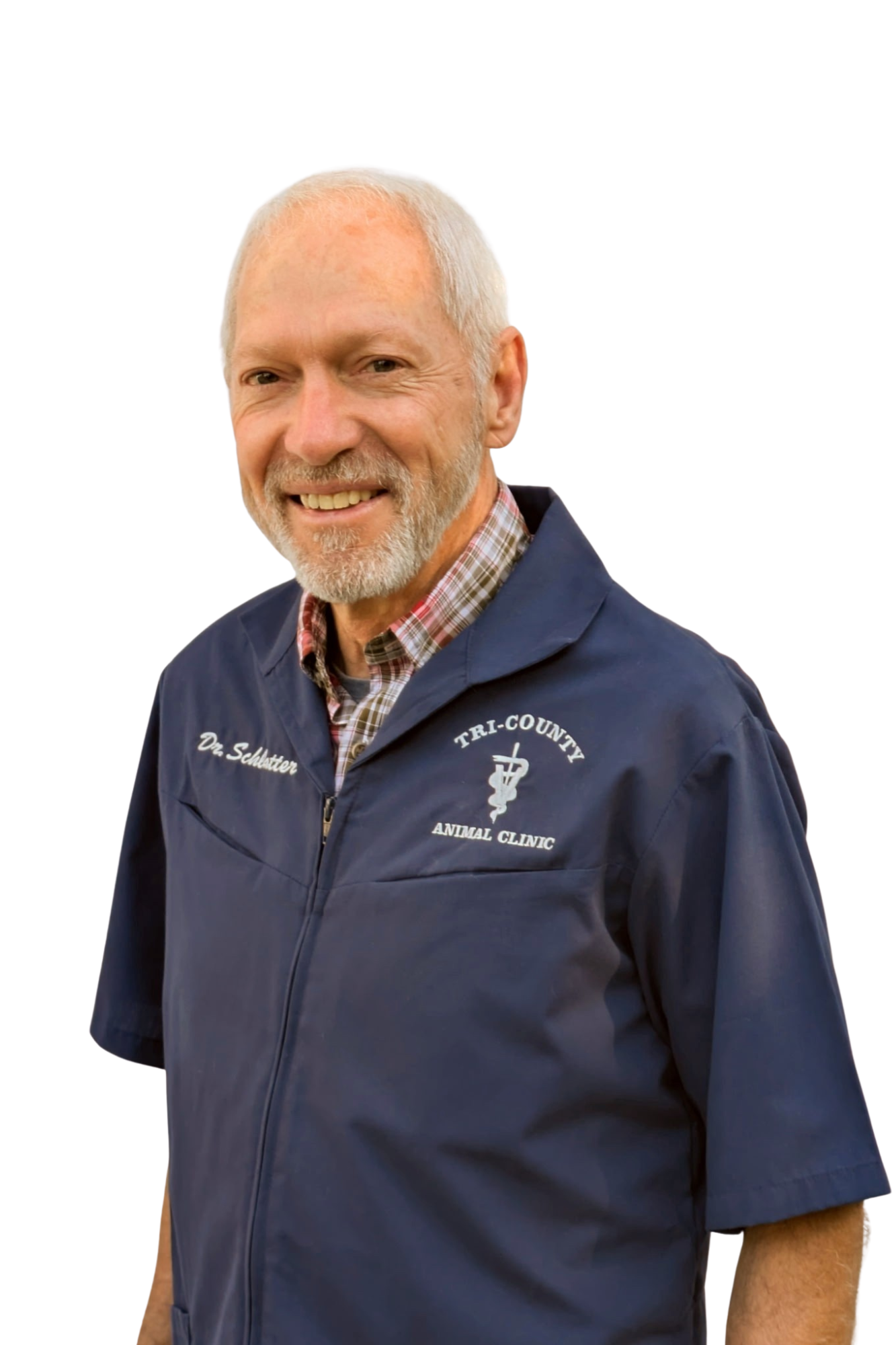 Portrait of a middle-aged man with white hair and beard, wearing a navy blue veterinary professional jacket embroidered with 'Dr. Schlatter' and 'Tri-County Animal Clinic', smiling against a white background.