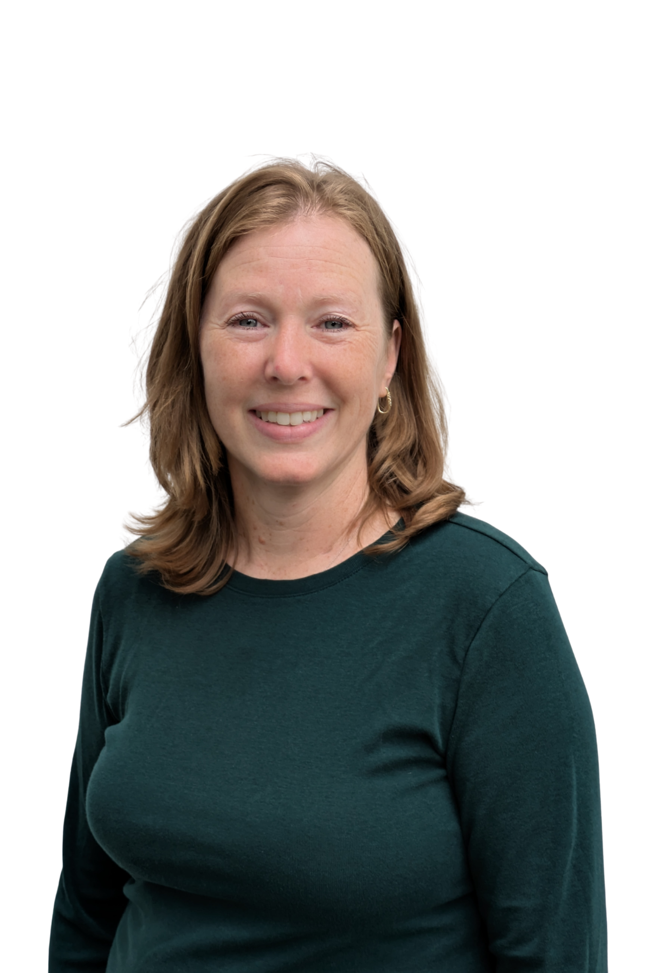 A woman with shoulder-length wavy brown hair, wearing a dark green long-sleeve shirt, smiling against a plain white background.