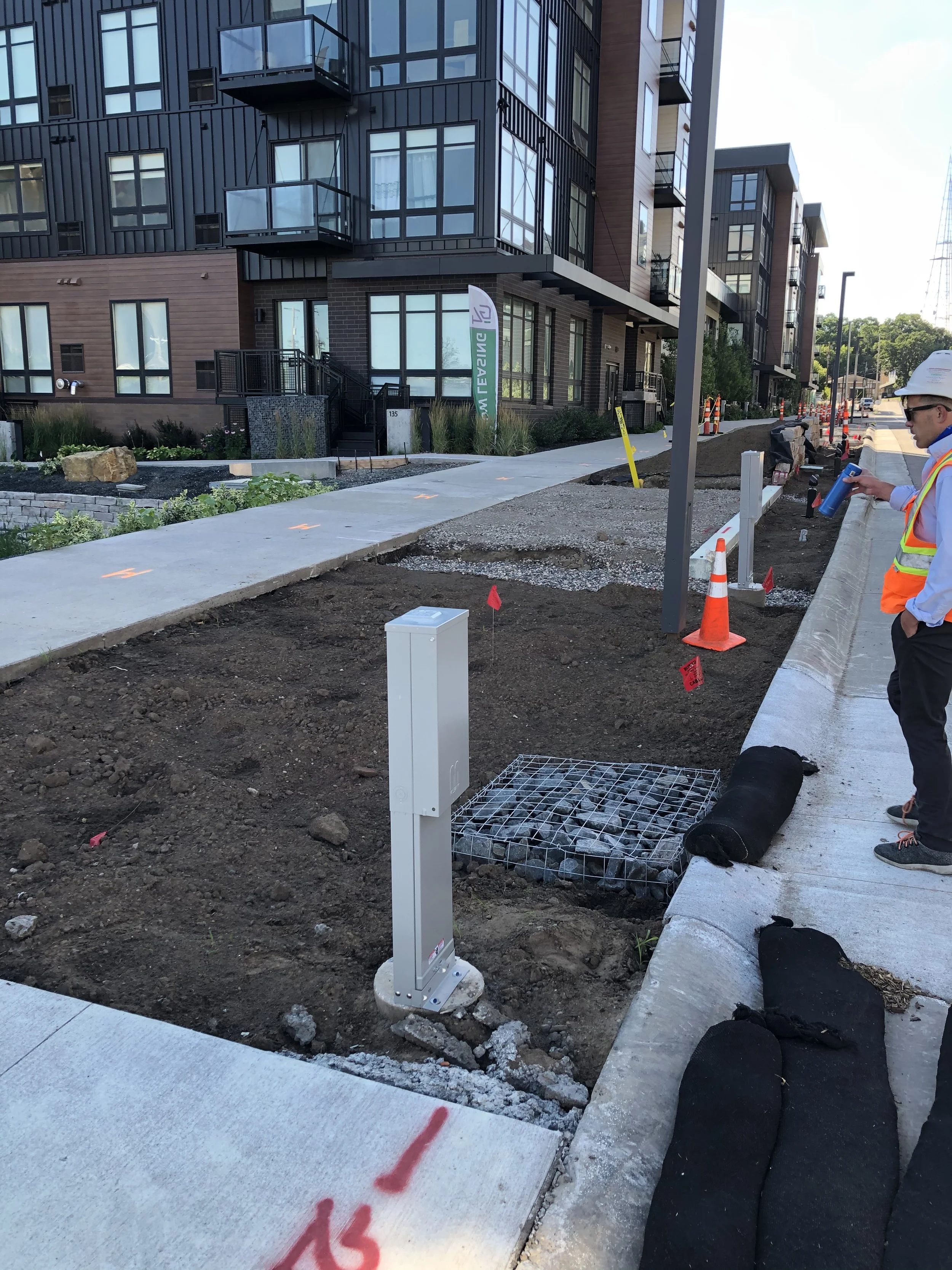 Tree trench construction with curb cut and electrical access for events
