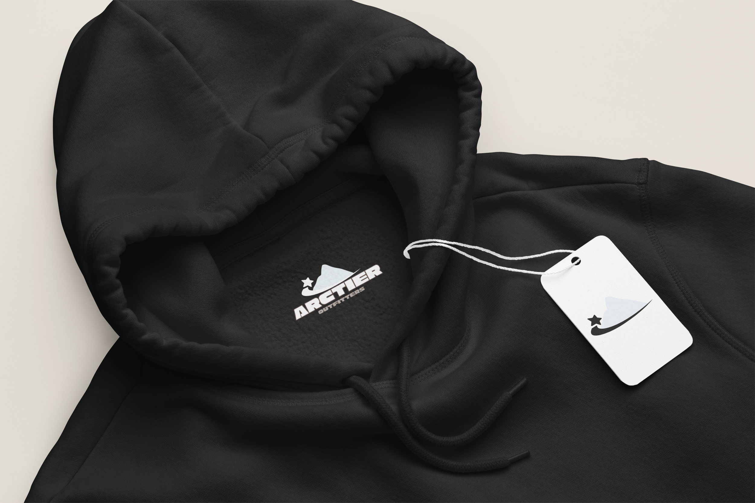 Black hoodie with Arctier Outfitters logo on the inside and a tag featuring a mountain and star