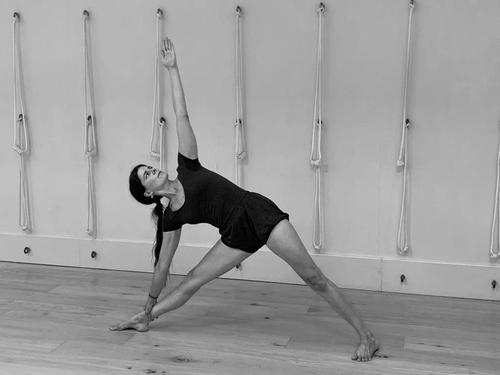 Woman practising Iyengar Yoga in an equipped Iyengar studio