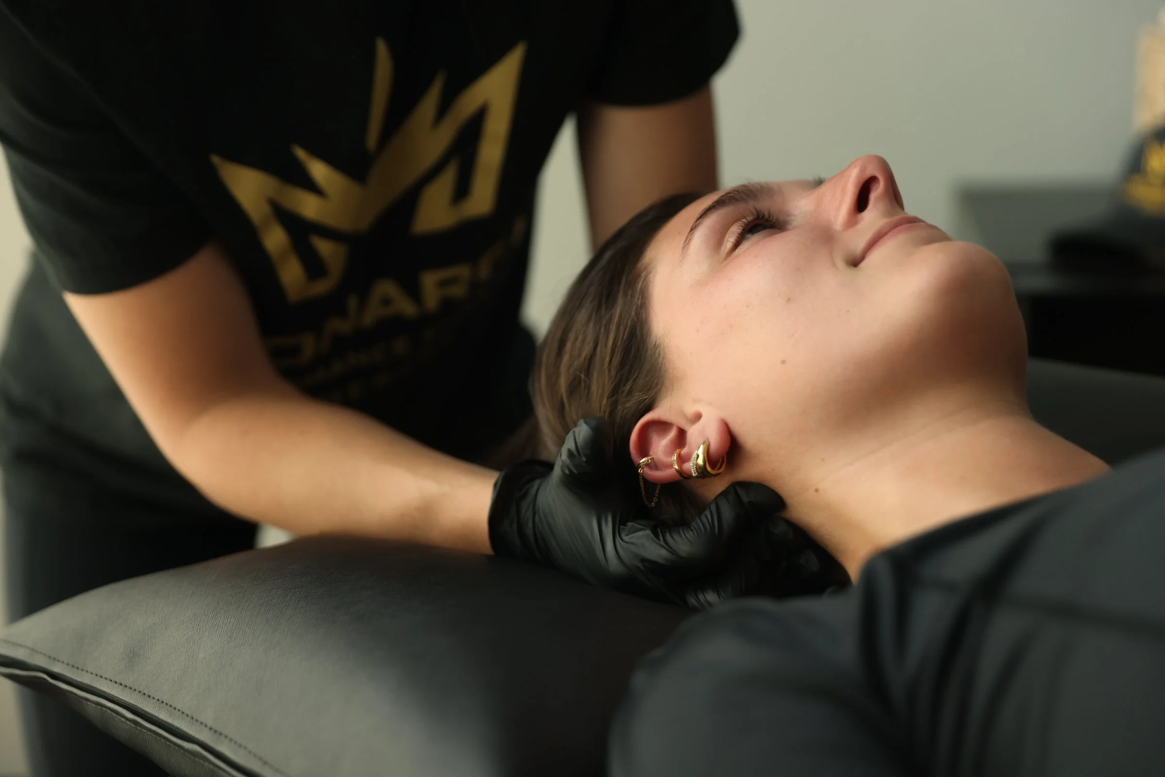 a sports physical therapist performing manual therapy for neck pain
