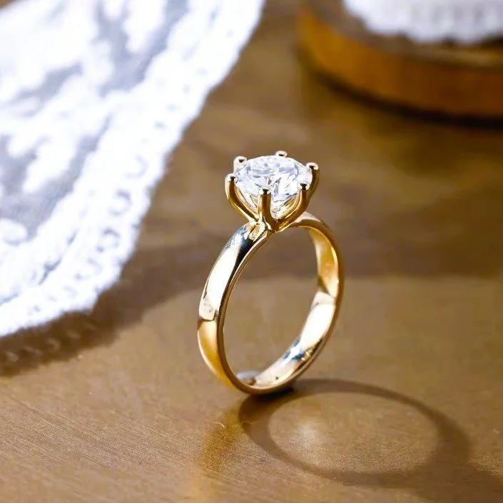 wide 14k gold band round cut diamond solitaire engagement ring from Mr Jeweler angled view.jpg