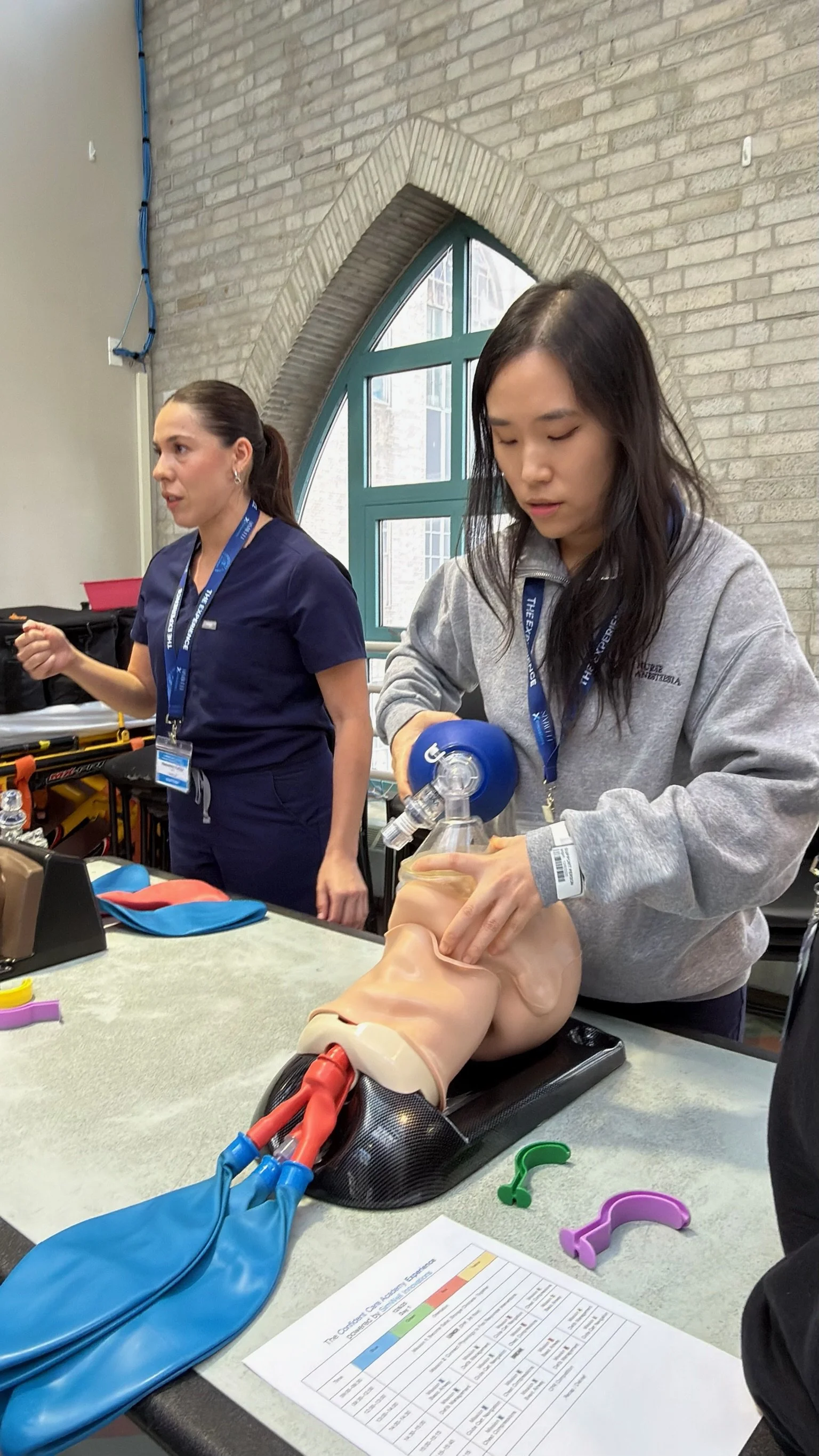 Participants practice bag-valve-mask airway management on a simulation manikin at the Confident Care Experience.
