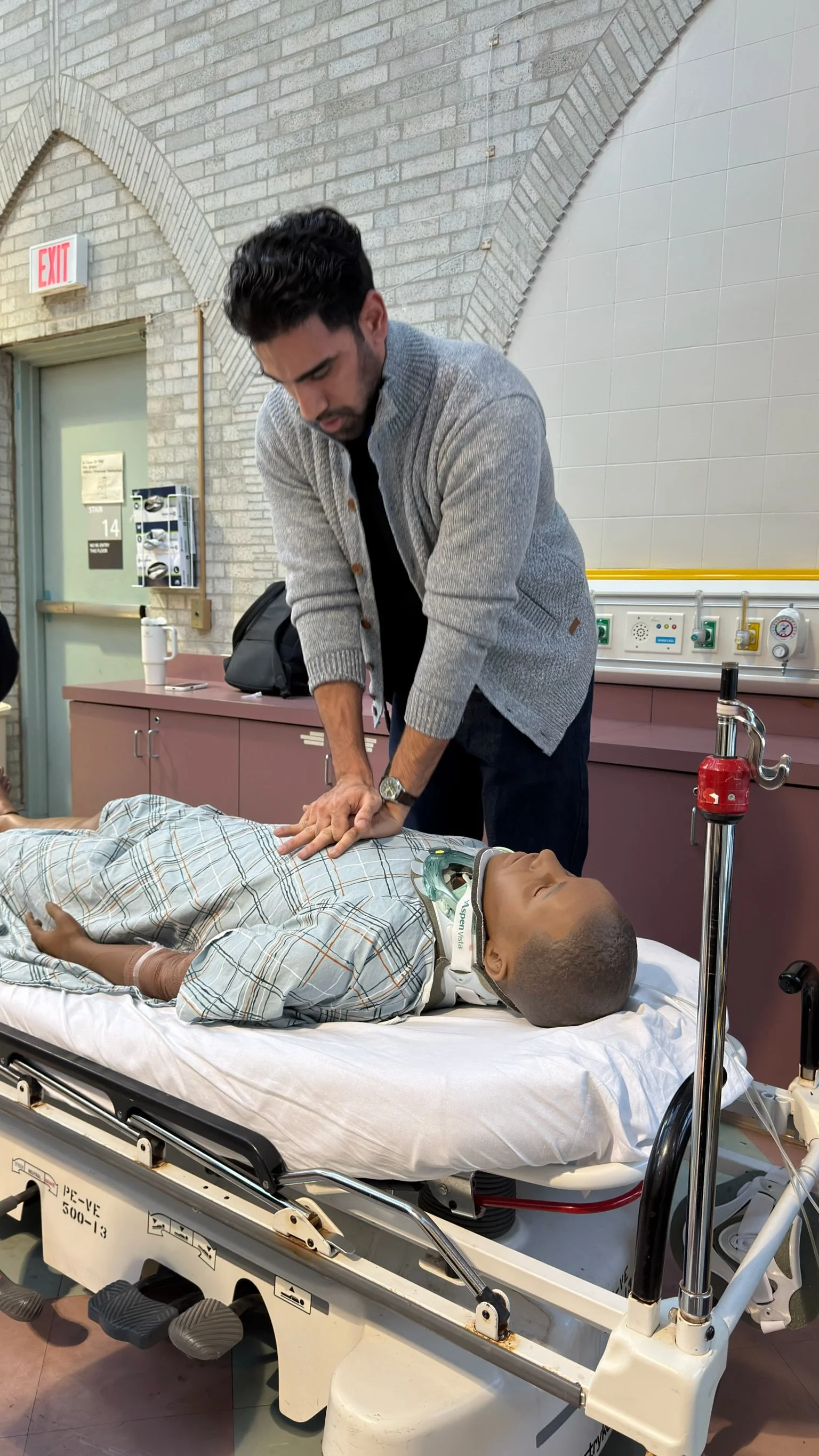 A participant performs a hands-on patient assessment scenario during the Confident Care Experience simulation event.