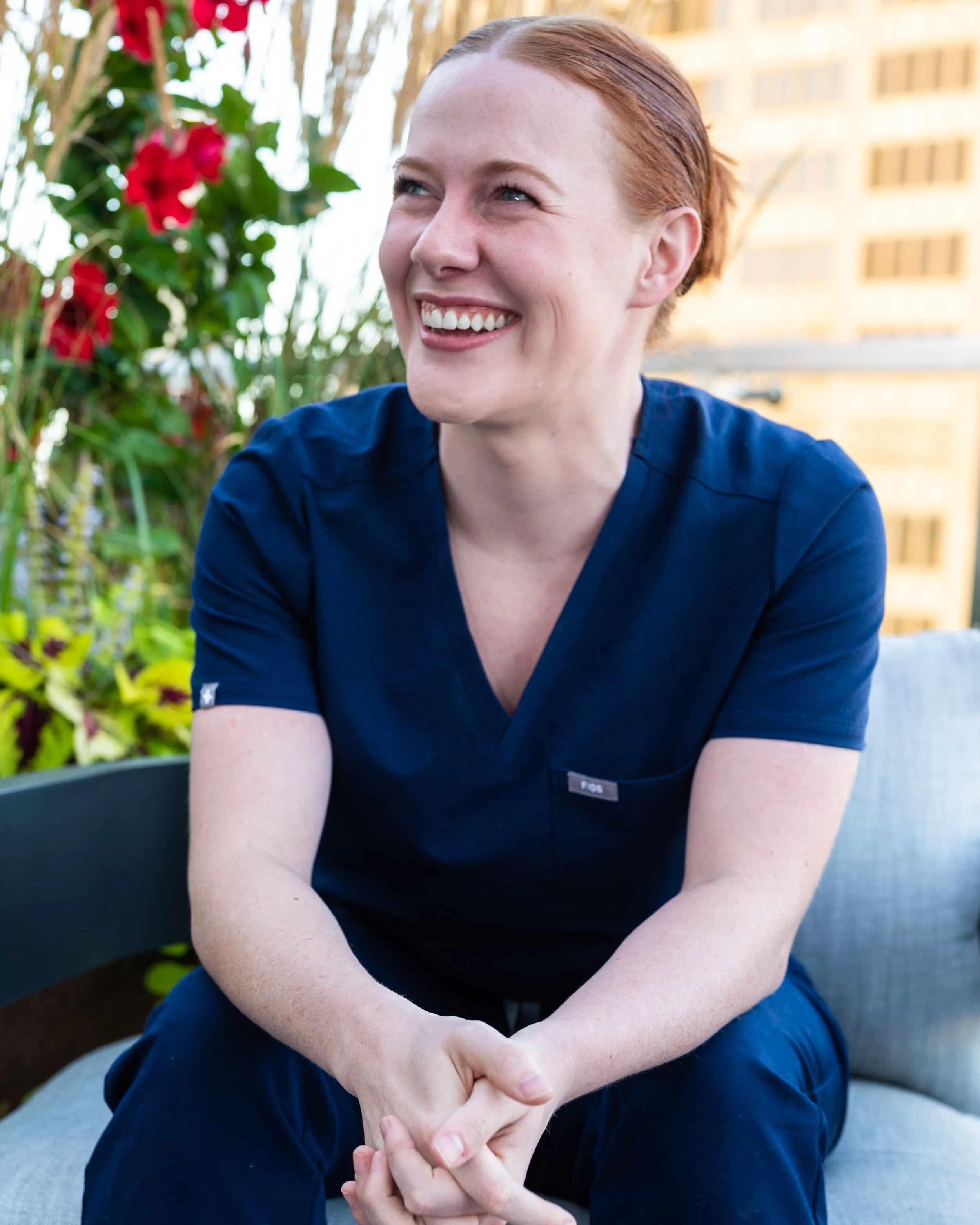 Anna Jobe, CRNA, co-founder of Confident Care Academy, laughing during an outdoor portrait session.