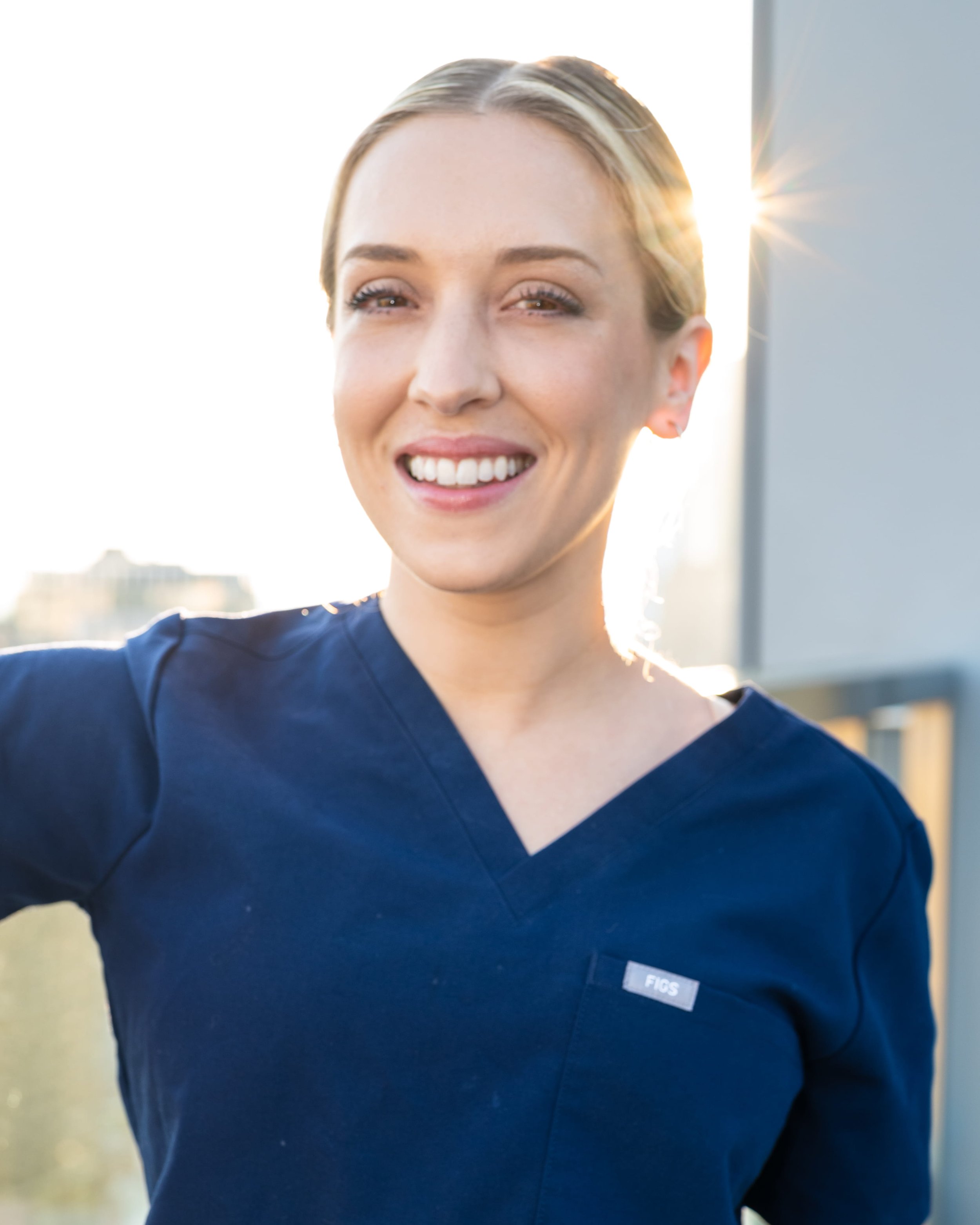 Chrissy Massaro, CRNA, smiles in a sunlit headshot, co-founder of Confident Care Academy.
