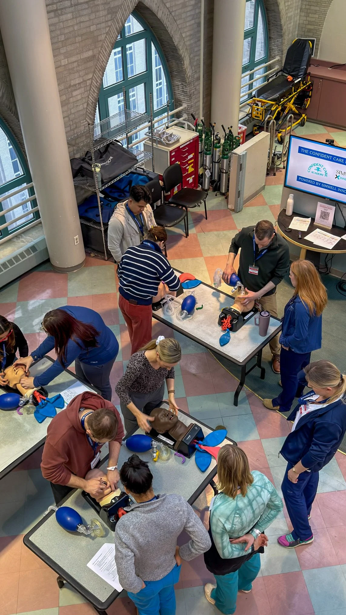 Nurses rotate through hands-on airway management and CPR stations during a Confident Care Academy skills workshop.