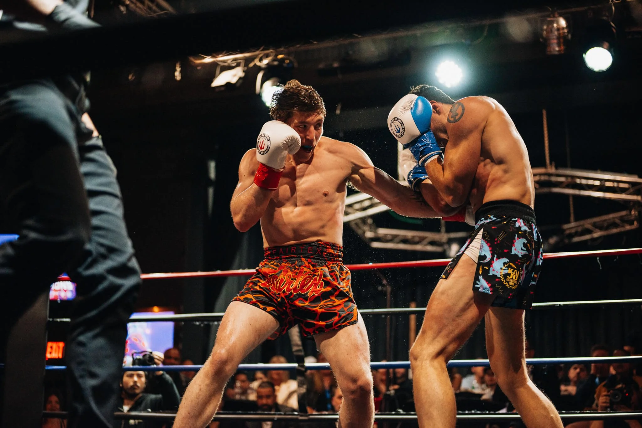 Two male fighters trade strikes during a Muay Thai fight at All City Fight Night in Everett.
