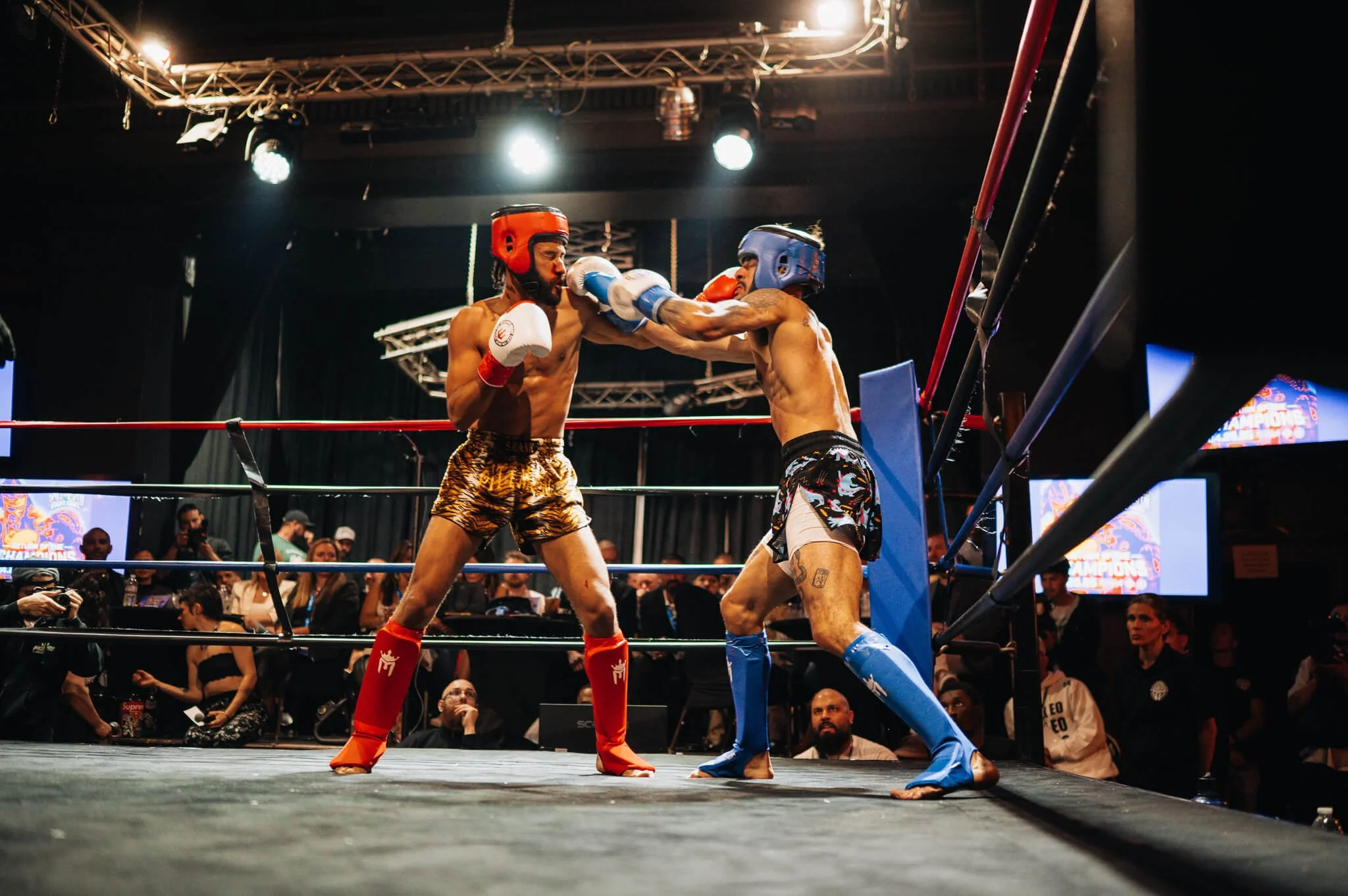 Two Muay Thai fighters exchanging punches during All City Fight Night in Everett WA