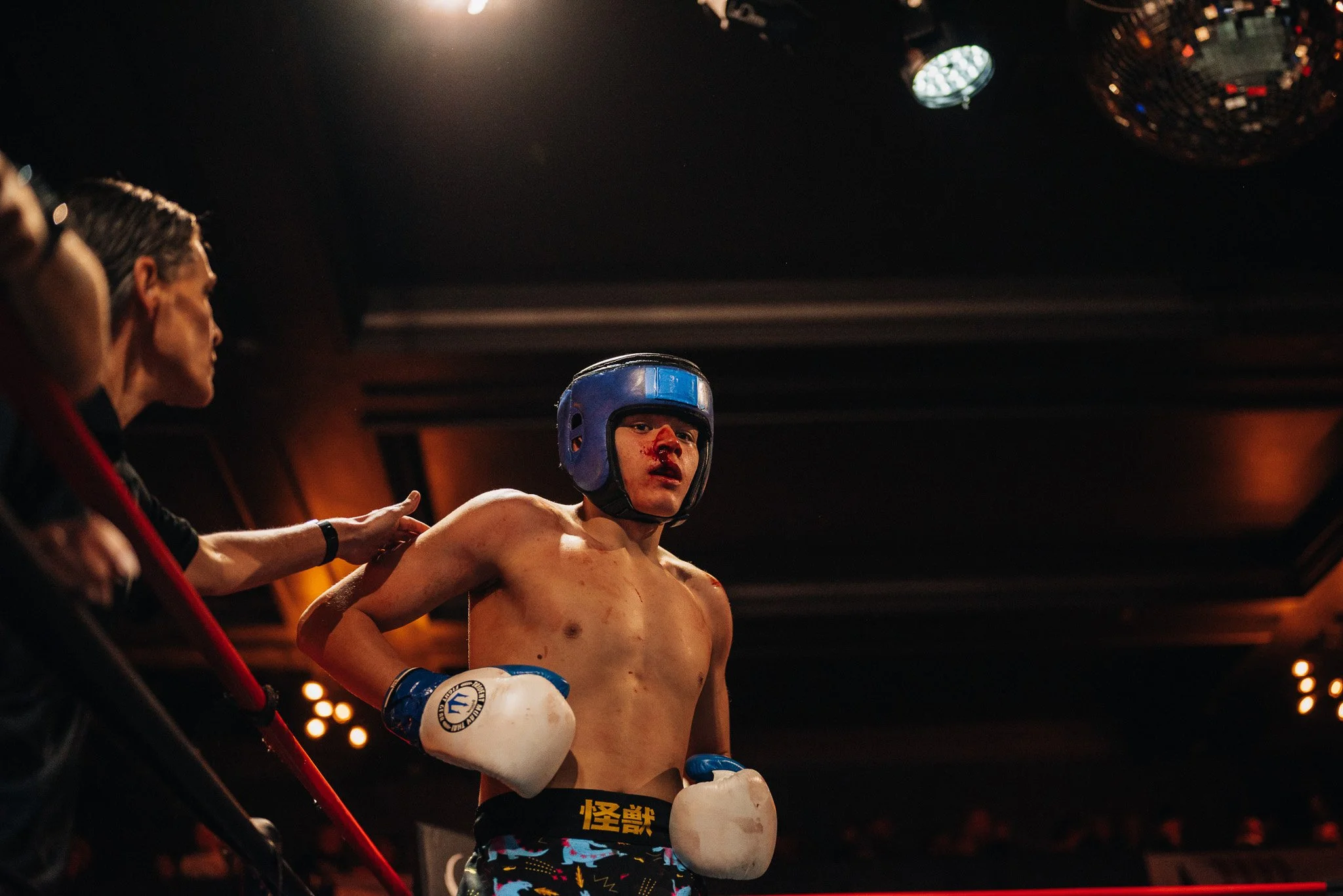 Kickboxing fighter with bloody nose standing in ring during All City Fight Night in Everett Washington