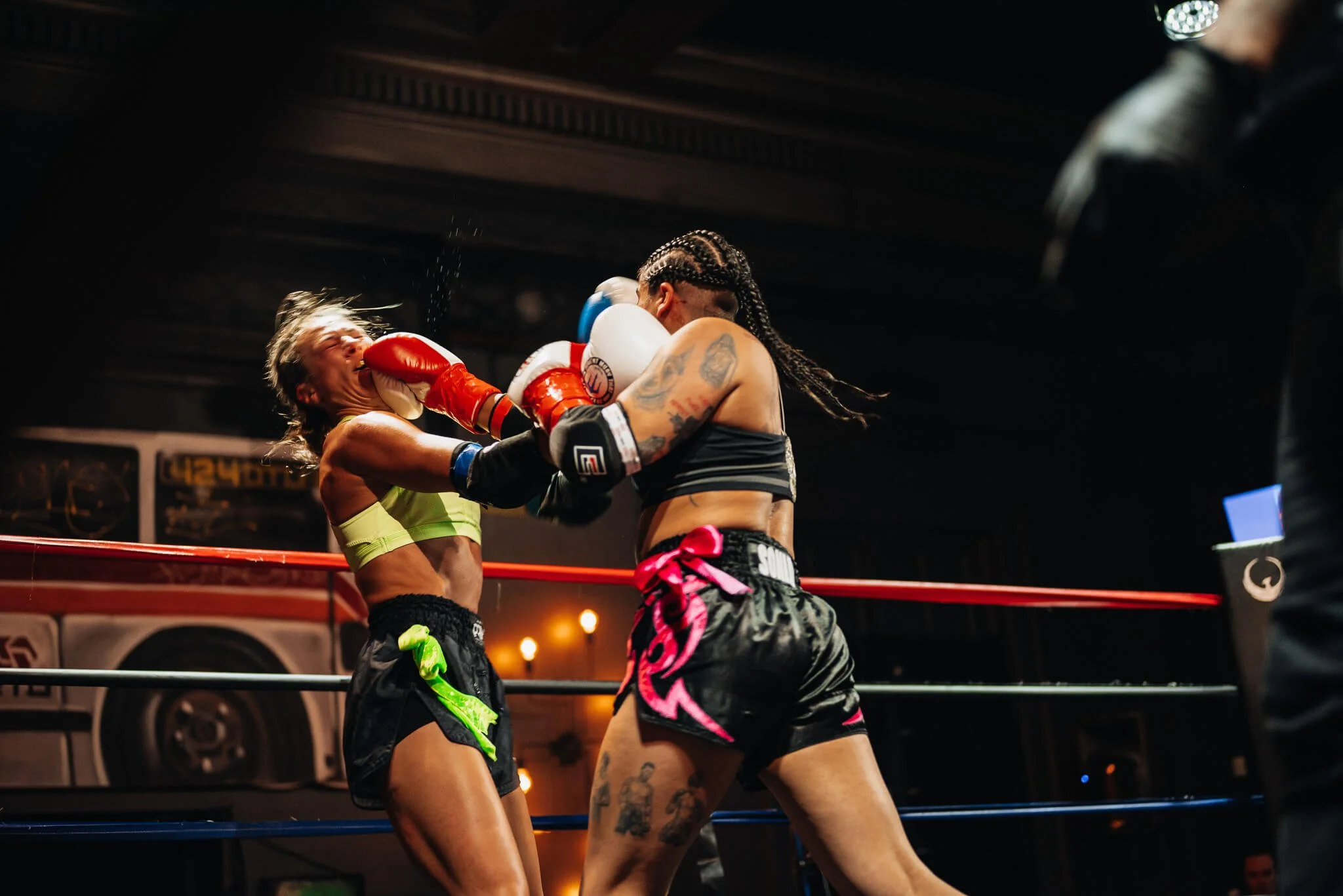 Two female Muay Thai fighters exchange punches during an All City Fight Night bout in Everett, Washington.