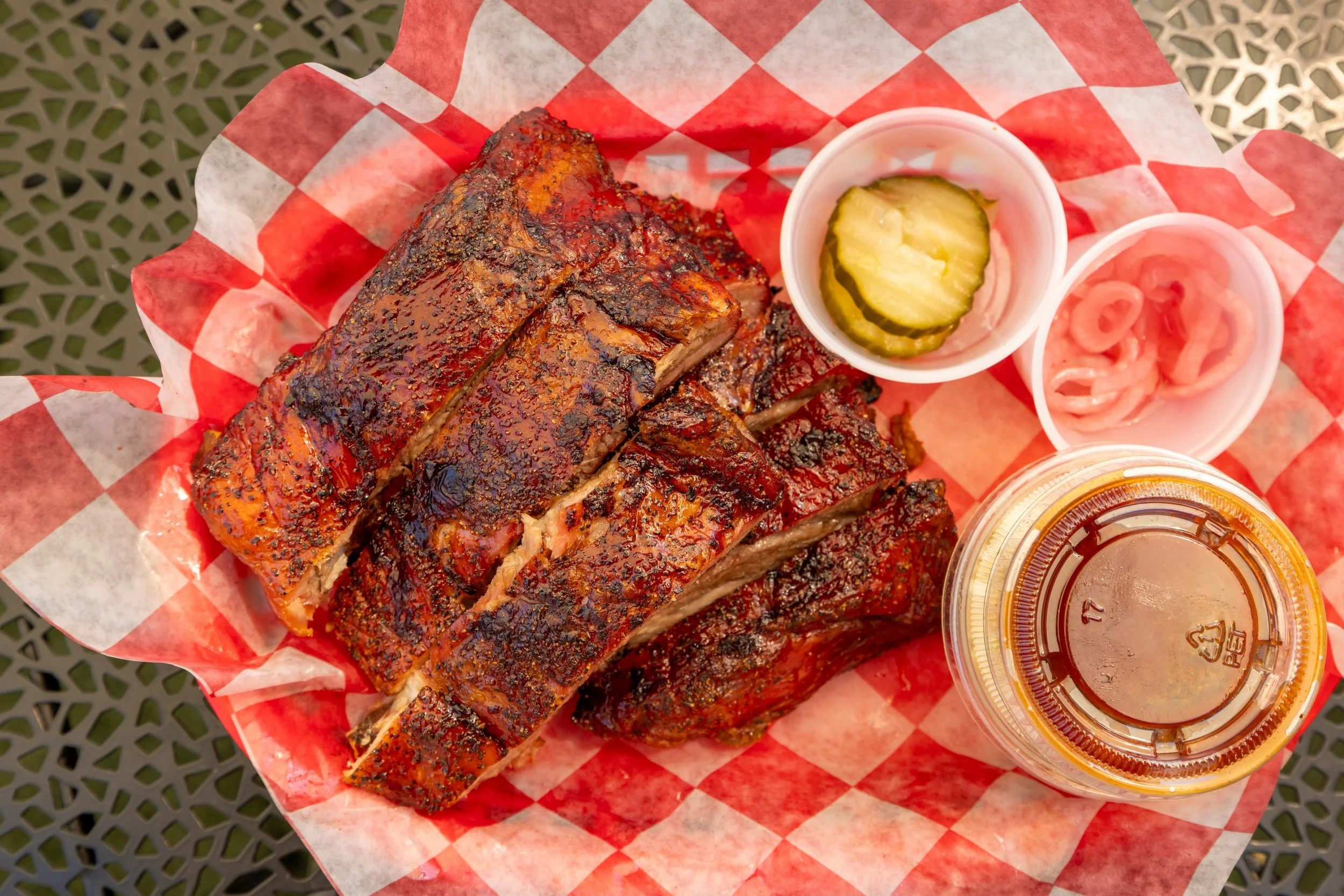 bbq ribs with sauce and pickles on the side