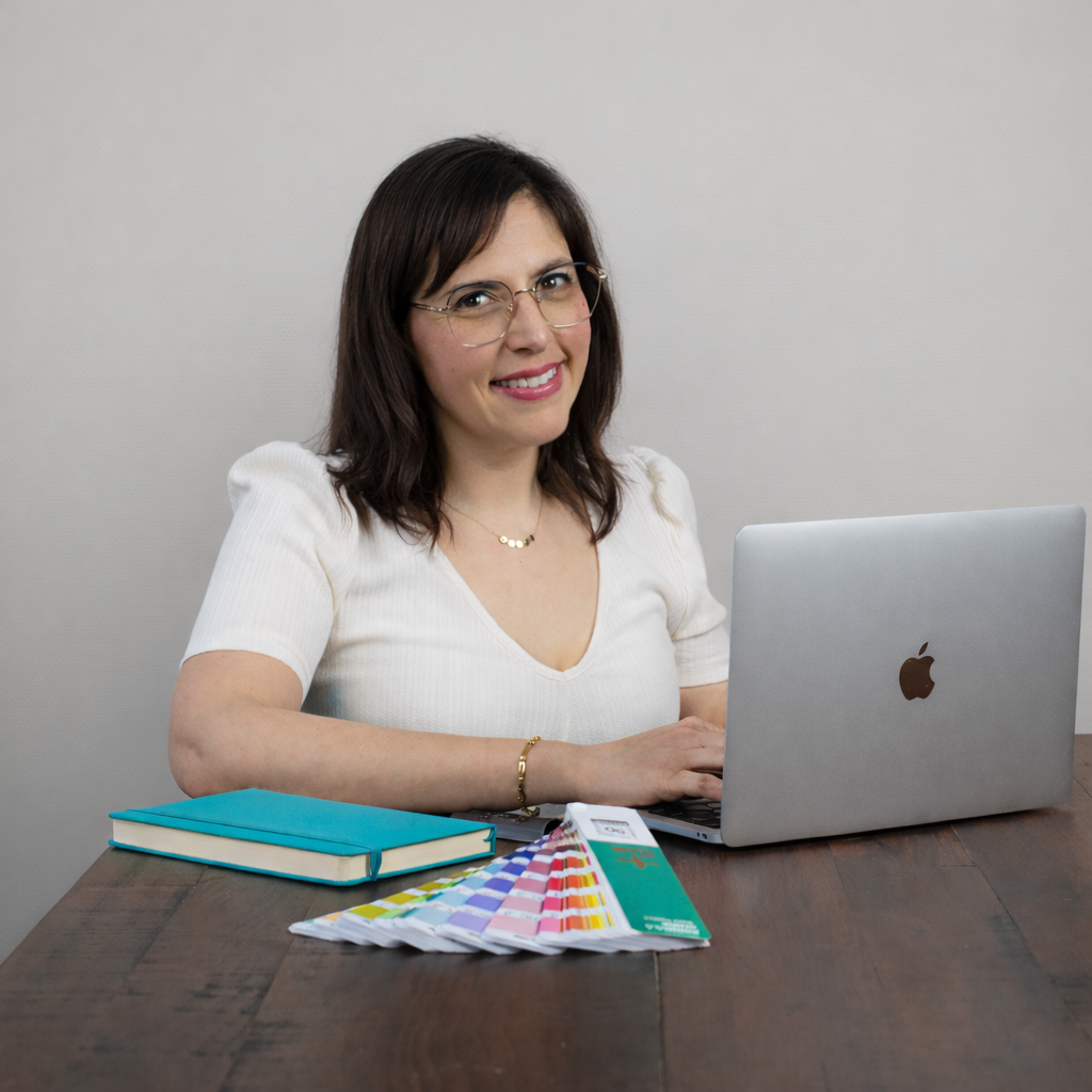 Ana sitting at a desk with pantone and sketch books