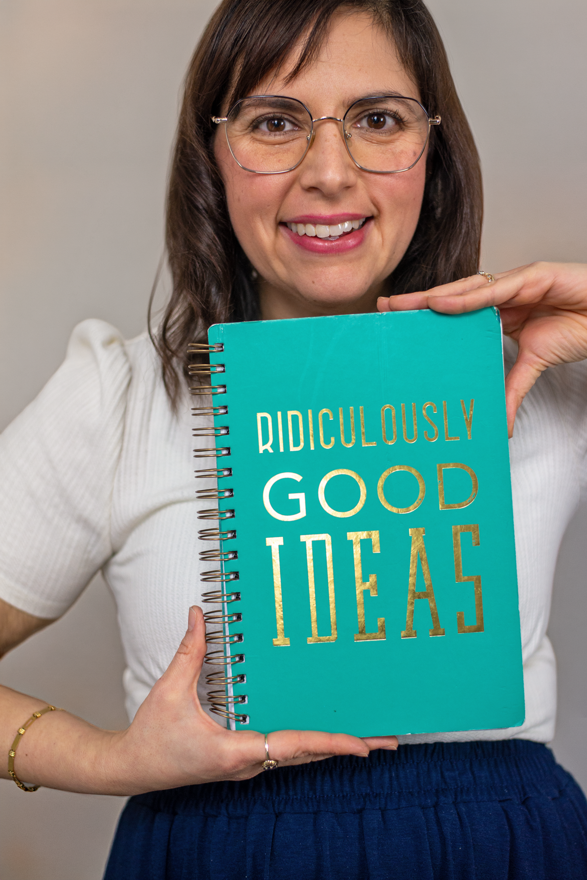Ana Miller holding a notebook that says ridiculously good ideas