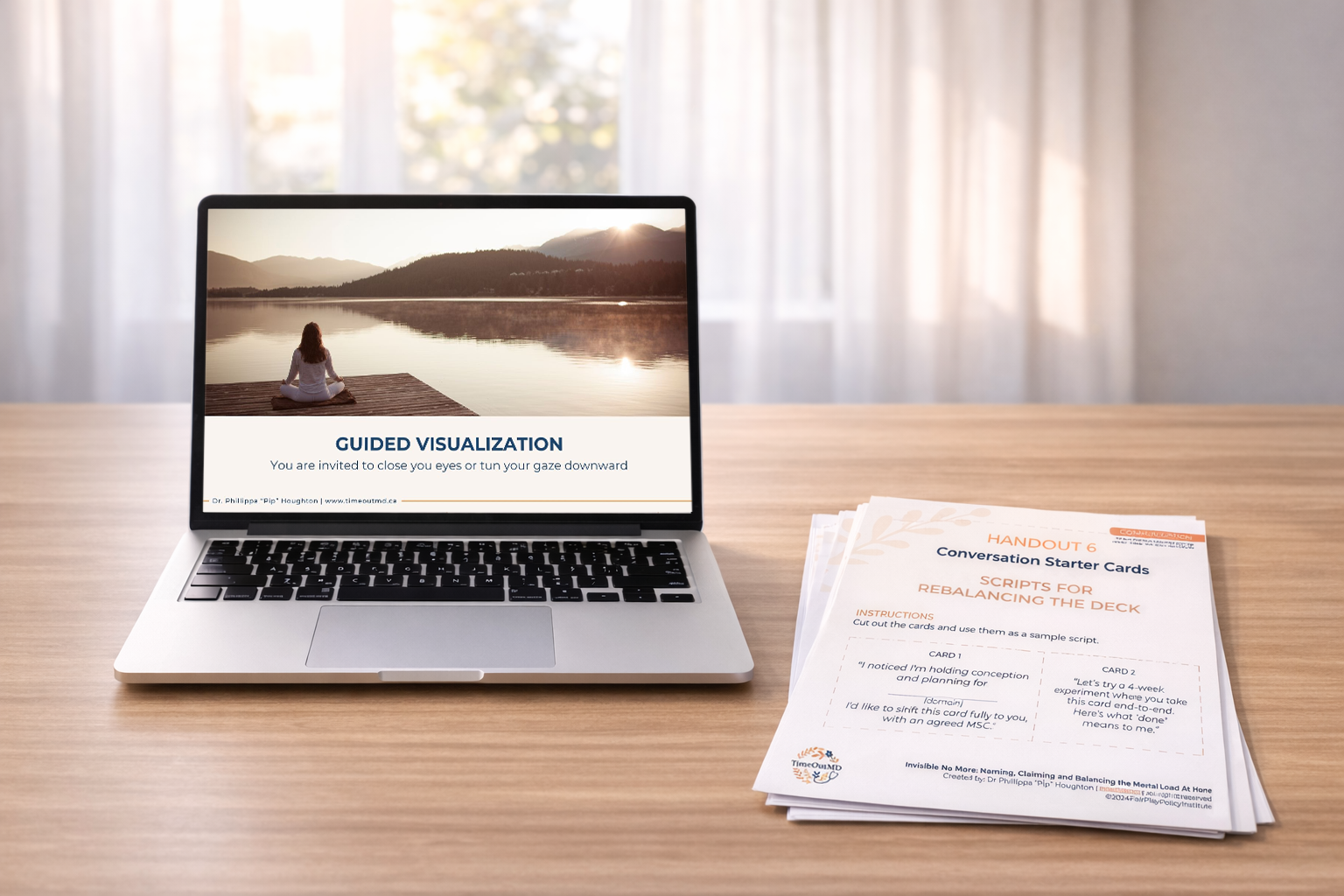 A computer with a presentation slide from a wellness retreat and handouts on a table