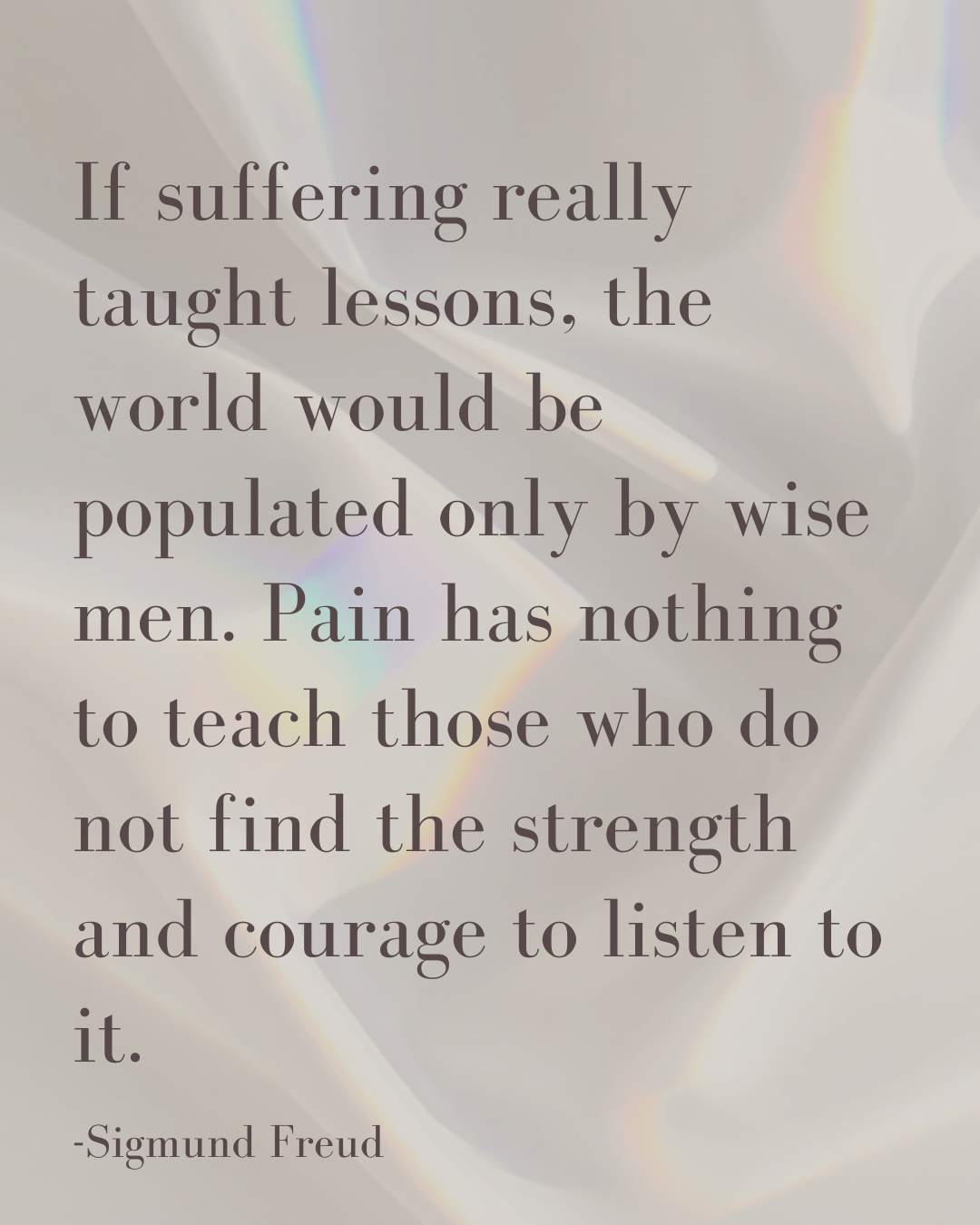 A quote by Sigmund Freud about suffering and lessons, with a background of soft, iridescent light reflecting off a surface.