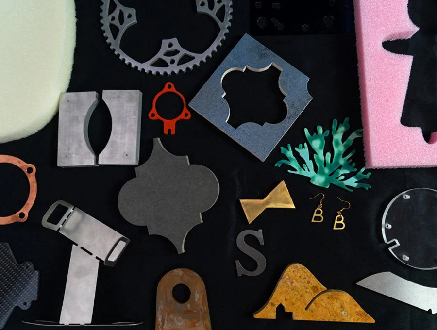 Collection of assorted metal and foam objects, including gears, frames, a coral-shaped decoration, earrings, and various shapes on a black background.