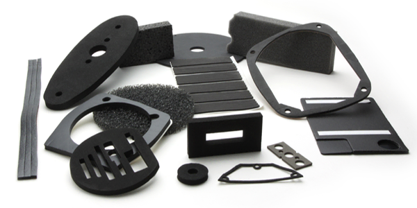 Collection of black and gray foam and rubber gaskets, pads, and seals arranged on a white background.