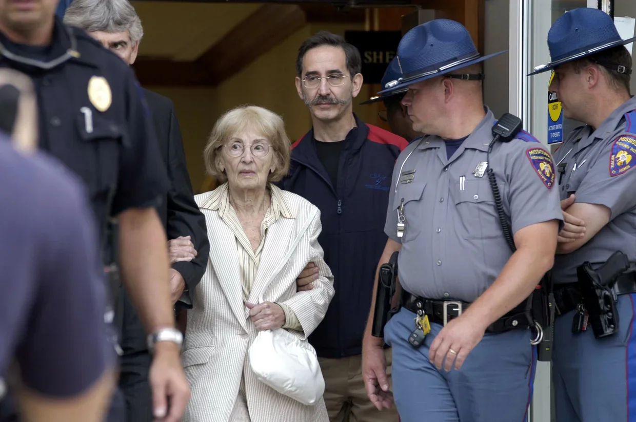 Dr. Carolyn Goodman, the mother of slain civil rights worker Andrew Goodman, leaves the Neshoba County Courthouse escorted by her son, David Goodman on June 17, 2005 in Philadelphia, Mississippi. Goodman, who lives in New York City, testified on the 