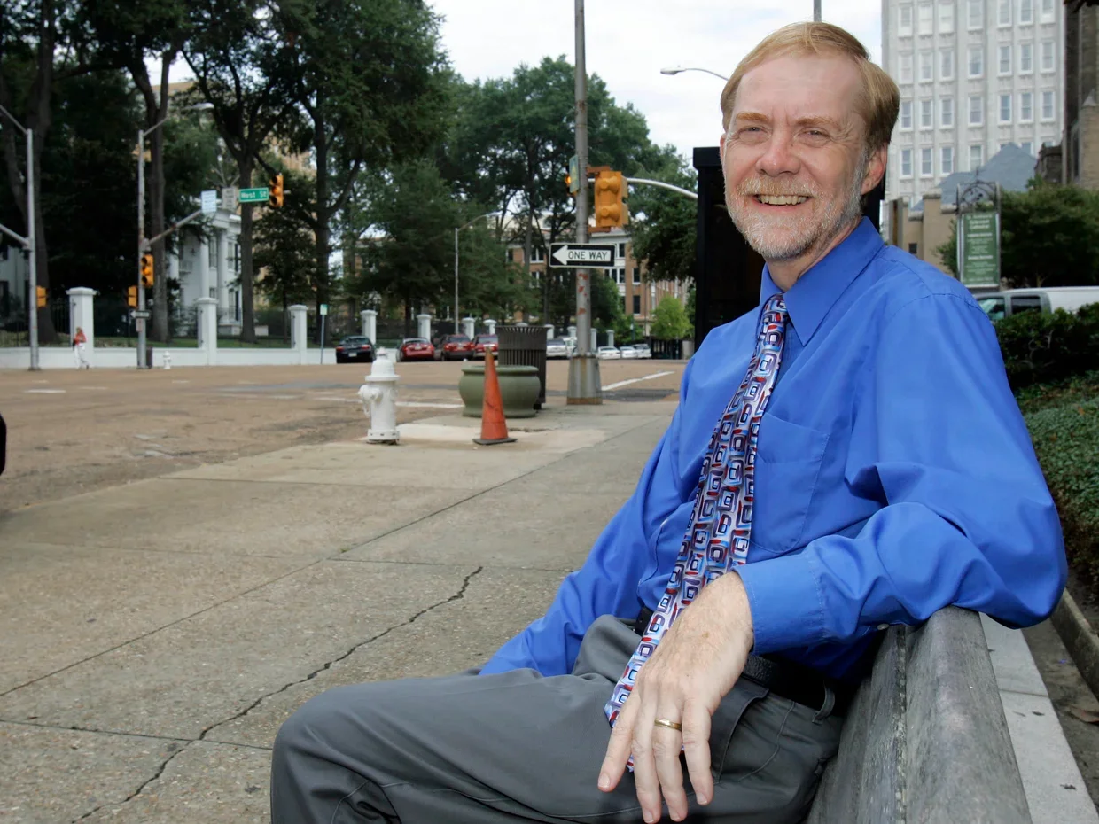 Clarion-Ledger newspaper investigative reporter Jerry Mitchell sits at a bus stand outside the federal courthouse in downtown Jackson, Miss., Monday, Sept. 21, 2009, where some of Mitchell's subjects have spent their last days of freedom, trying to "