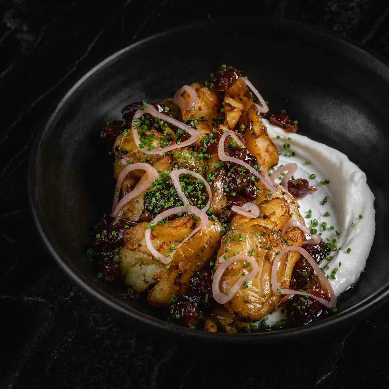 Potatoes, crisped in beef fat then served with a smear of koji sour cream and dollops of Chinese sausage jam.