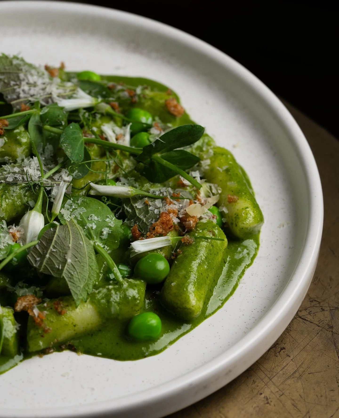 A spring collaboration with Chef Tara and Sous Chef June. Their Perilla Pesto Tteokbokki features an herb pesto made with perilla, served with rice cakes, peas, yuzu, parmesan, and garlic bread crumbs.
