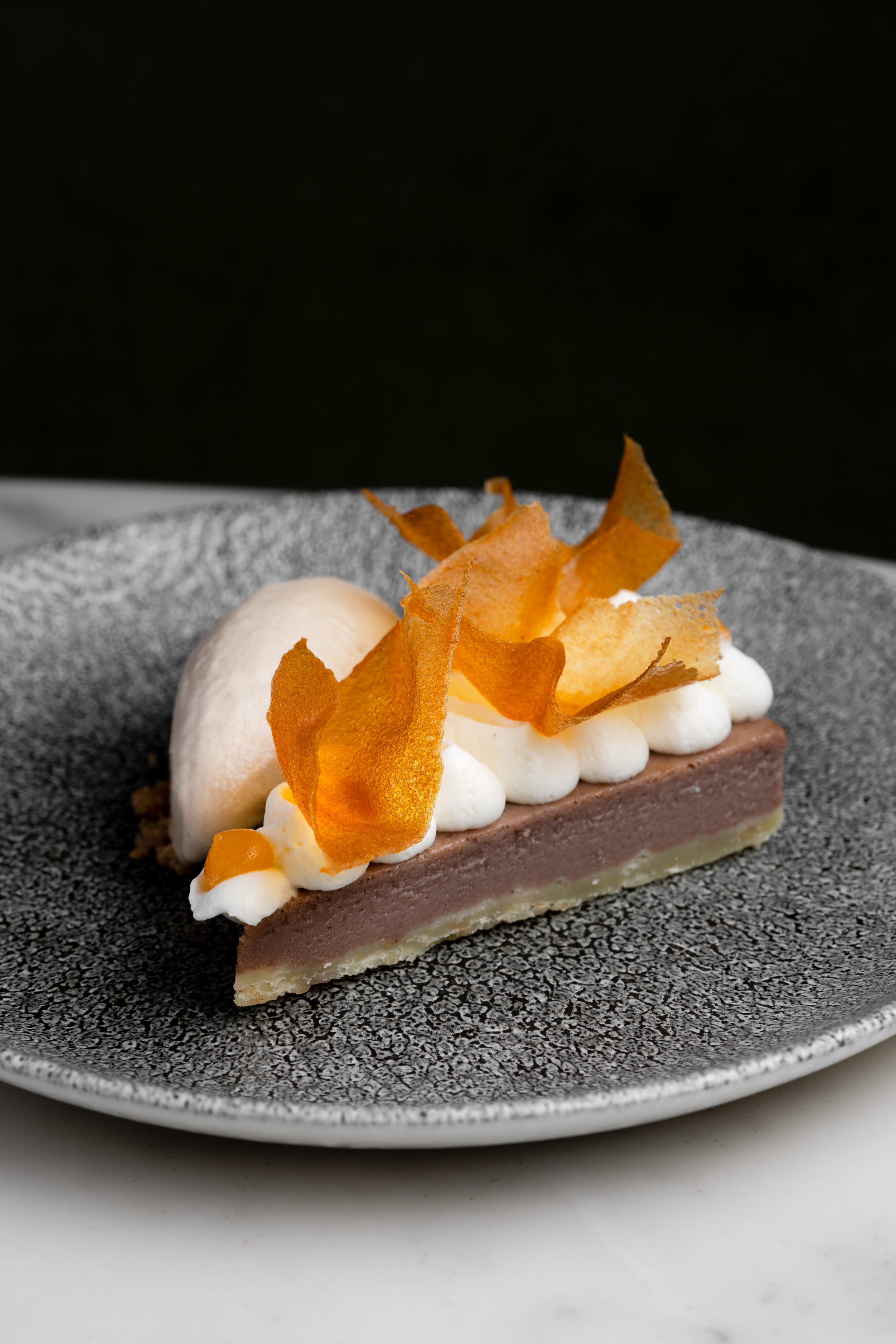 Turon tart with caramelized brown sugar custard, banana ice cream, and caramel tuile shards at Animae San Diego