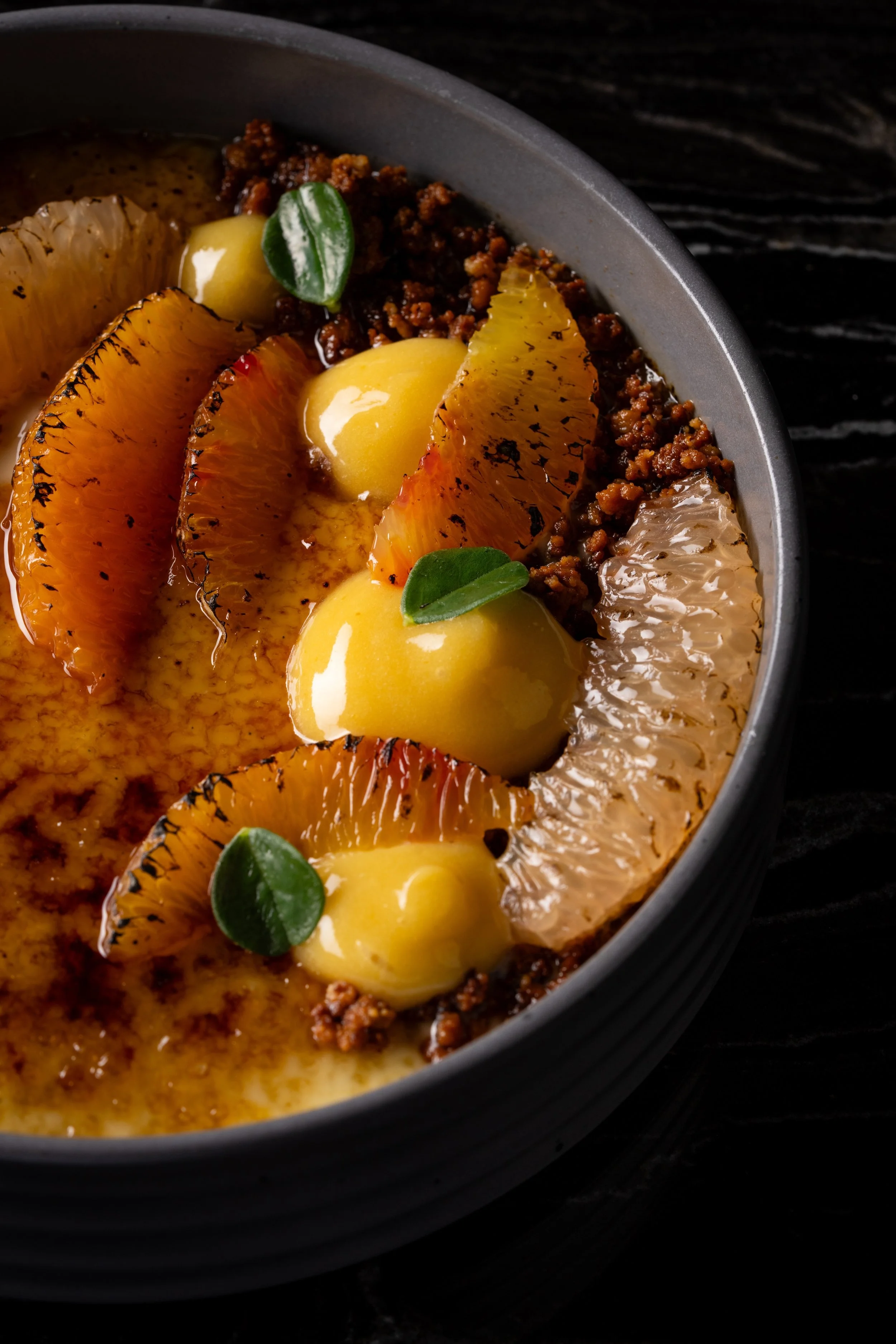 Sticky rice crème brûlée with fresh citrus, blood orange, kumquat, and latik at Animae San Diego