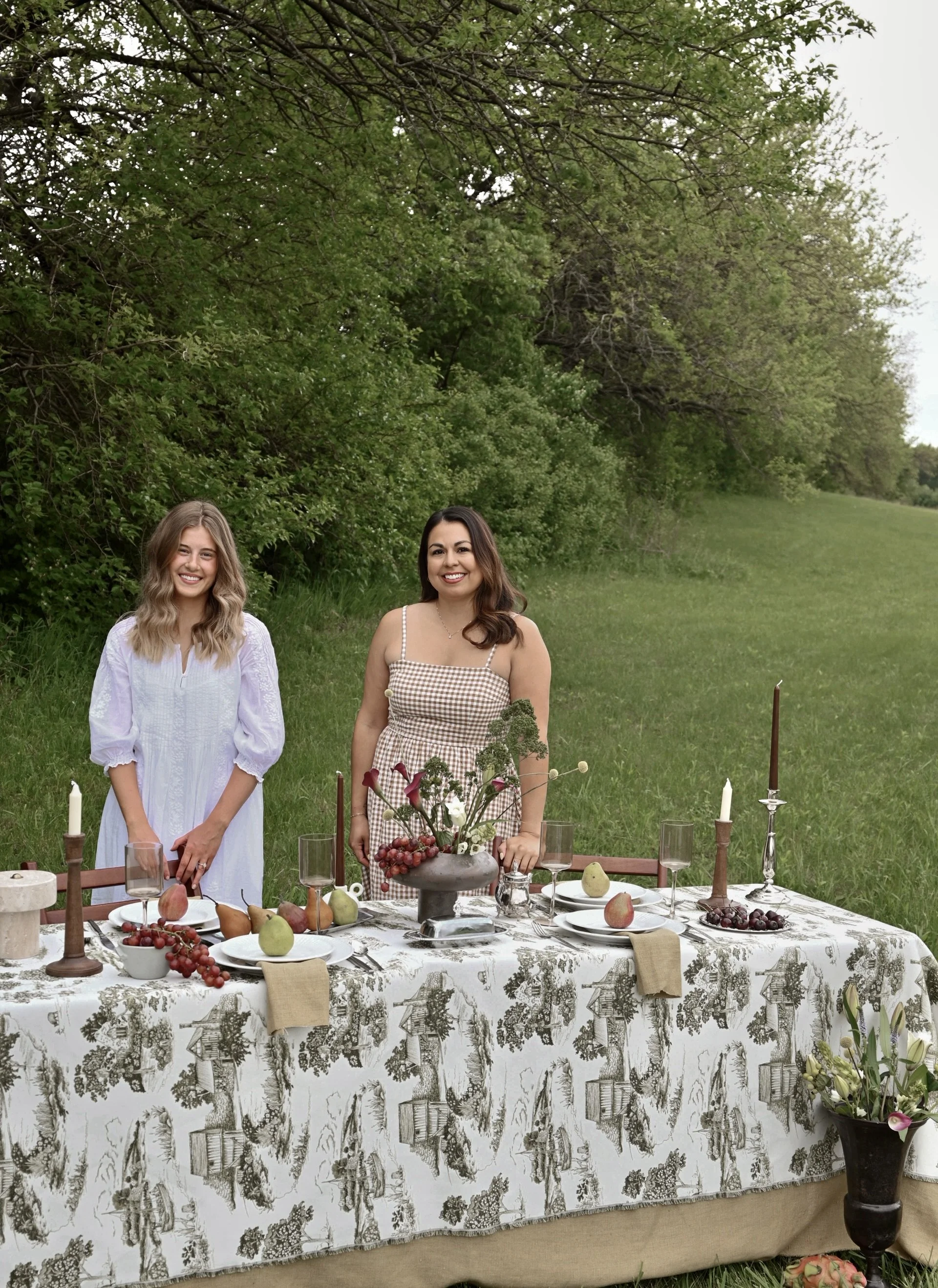 Texturious Designs interior designers Jen Munoz and Kayla VanHorn with a styled outdoor tablescape in Des Moines, Iowa.