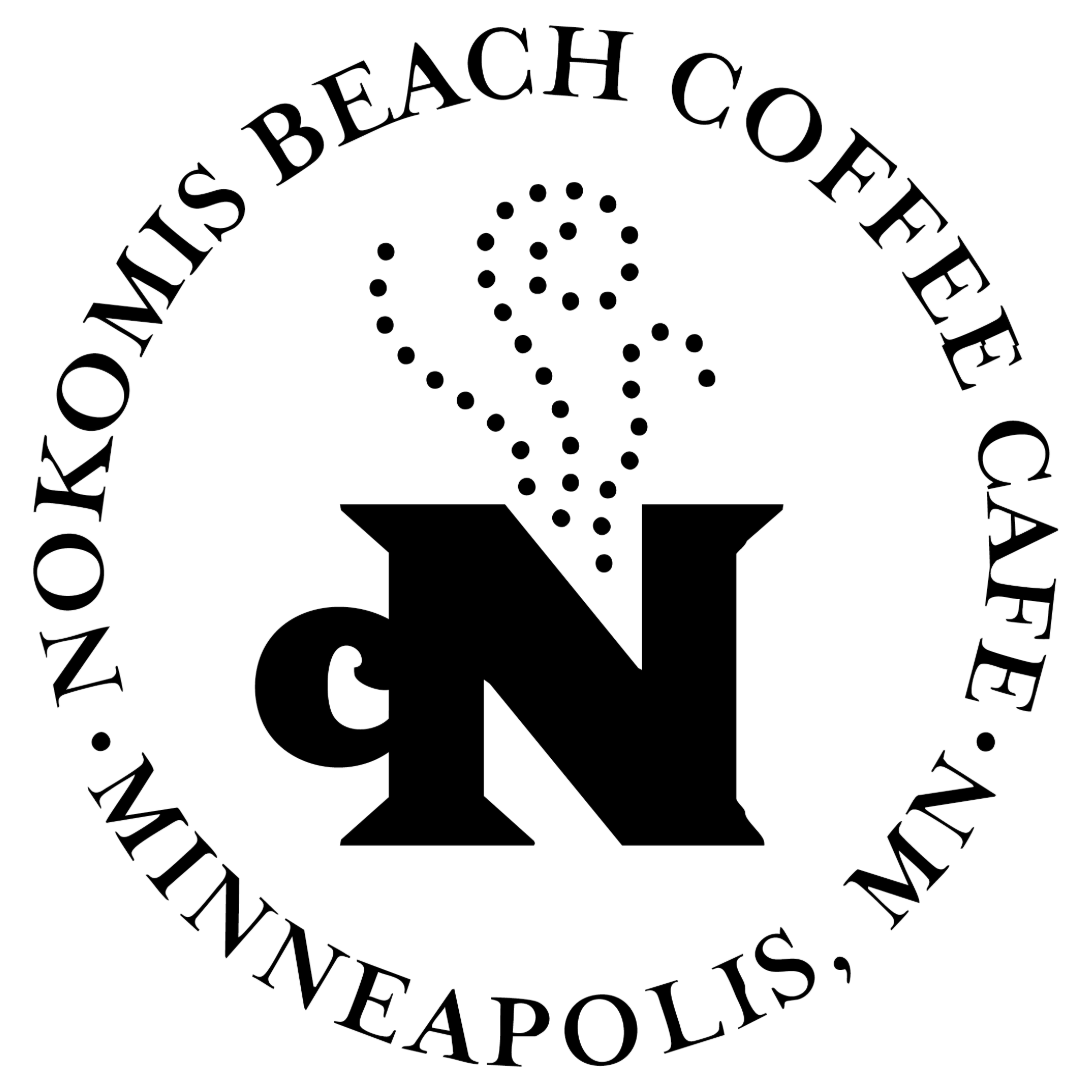 Black and white logo for Monks Beach Coffee Cafe in Minneapolis, MN with a large Greek letter 'N' in the center, surrounded by light-colored dots creating a design resembling a steaming coffee cup or abstract vapor.